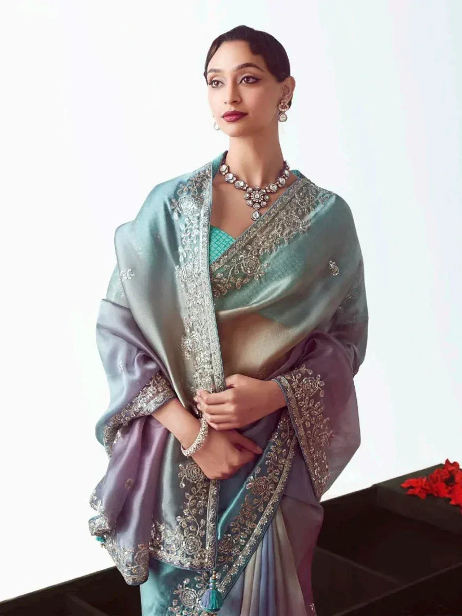Elegant teal and lavender saree with intricate embroidery and jewelry, perfect for Indian ethnic occasions