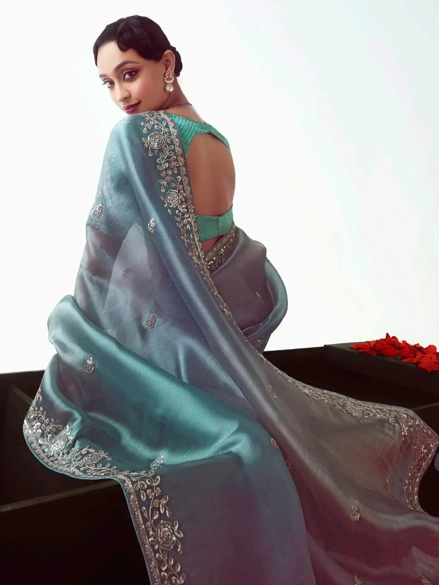 Elegant teal saree with silver embroidery, perfect for Indian ethnic wear and designer occasions