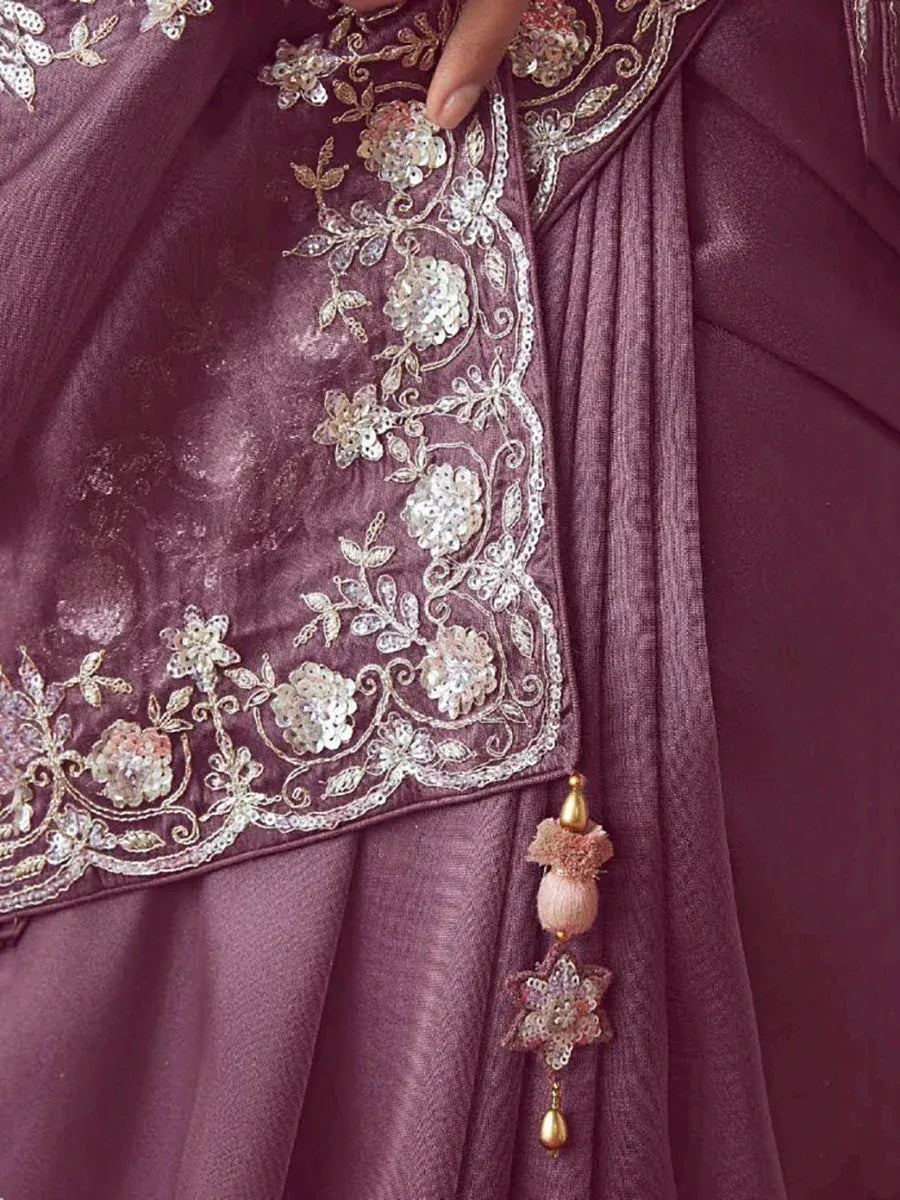 Elegant maroon saree with floral sequin embroidery and tassel detail, perfect for ethnic occasions.