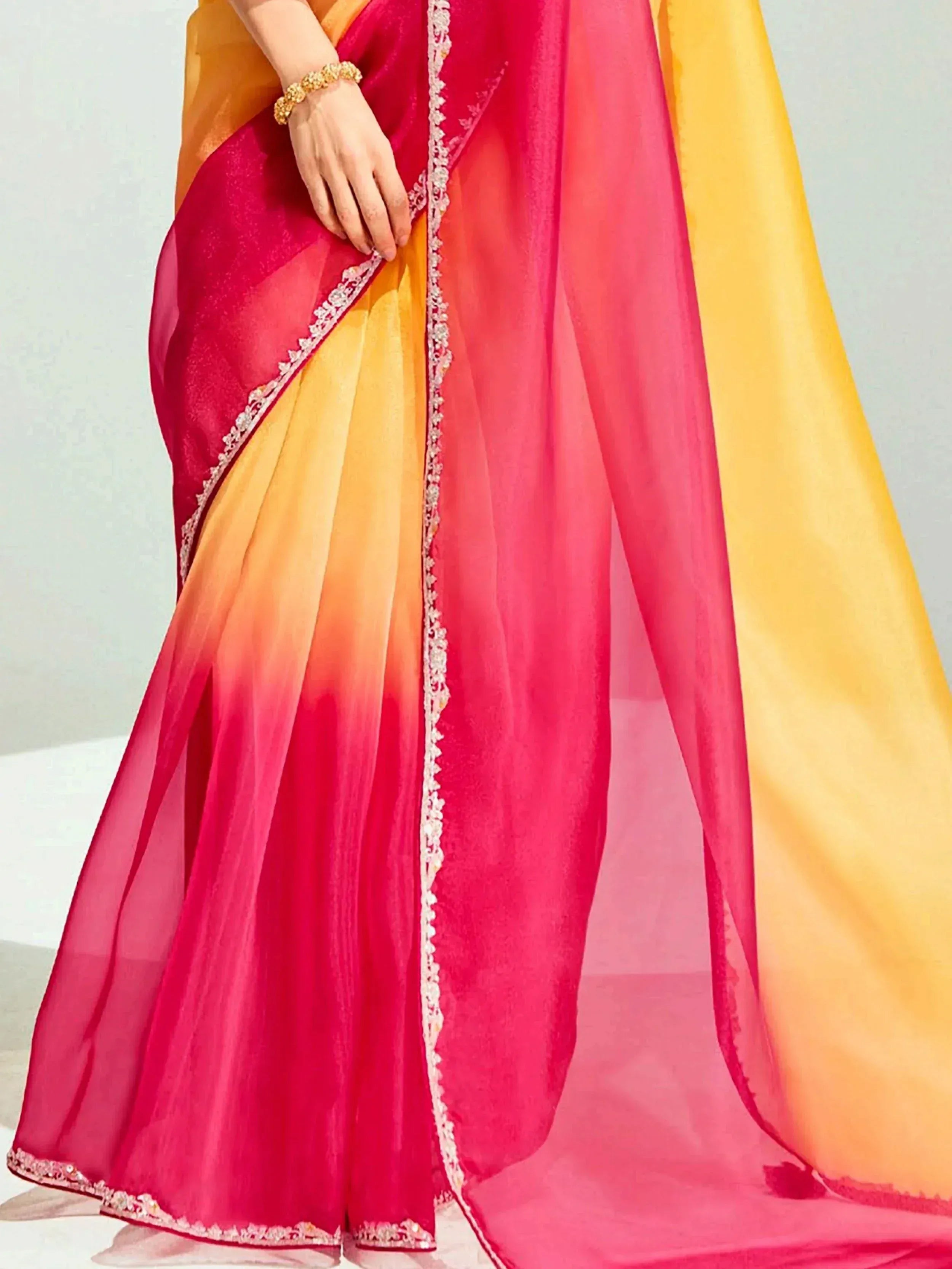Vibrant pink and yellow ombre saree with delicate embroidery, perfect for Indian ethnic wear occasions.