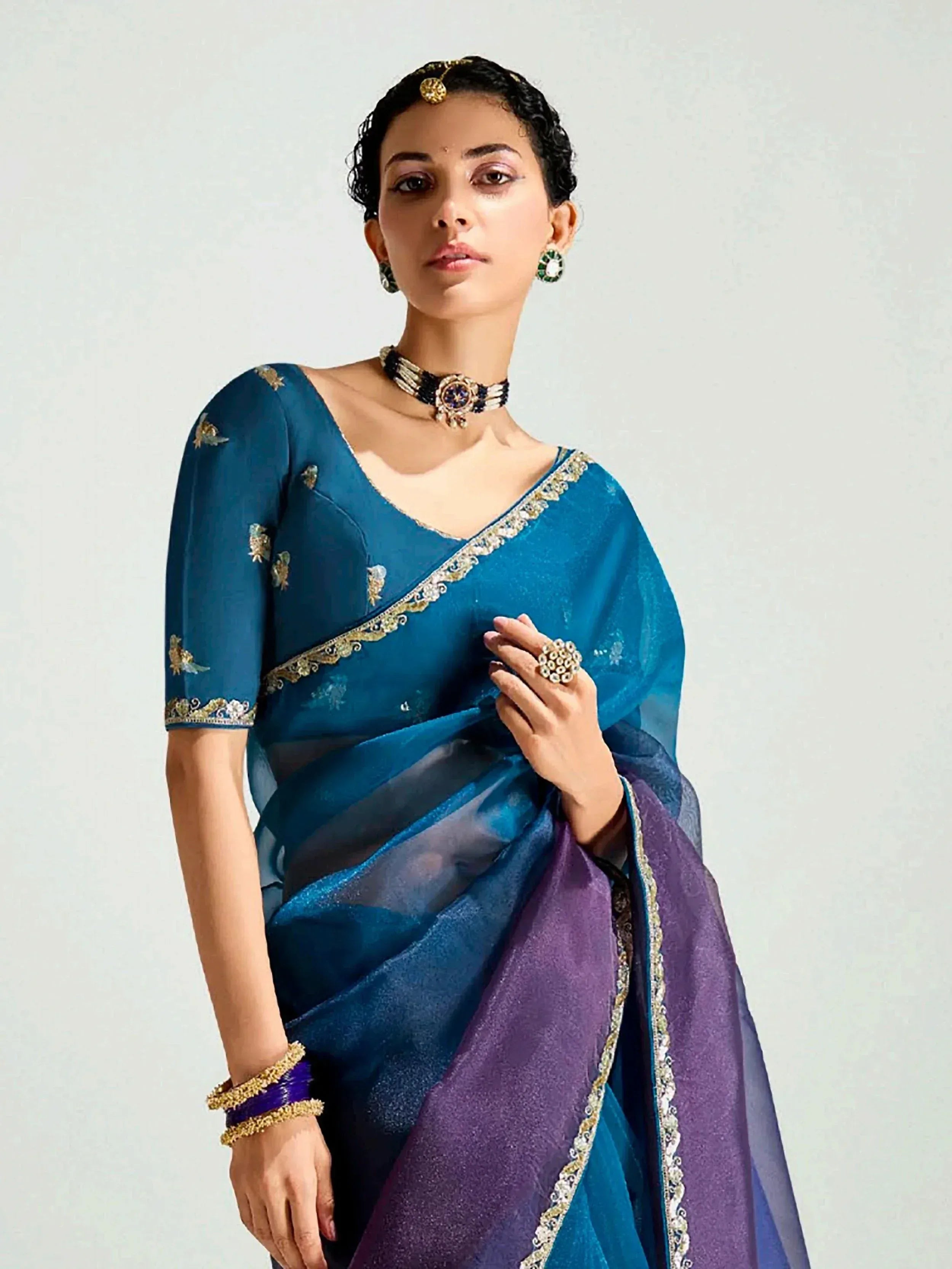 Blue and purple embroidered saree with gold detailing, perfect for Indian ethnic wear occasions