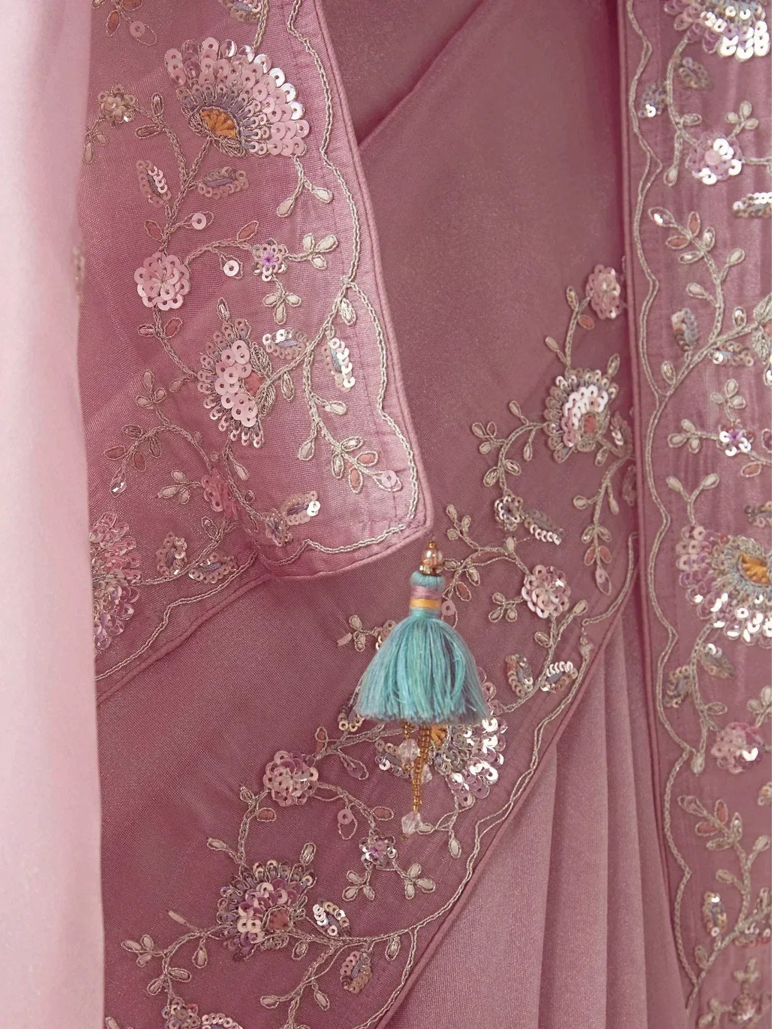 Pink ethnic gown with floral sequin embroidery and turquoise tassel detail