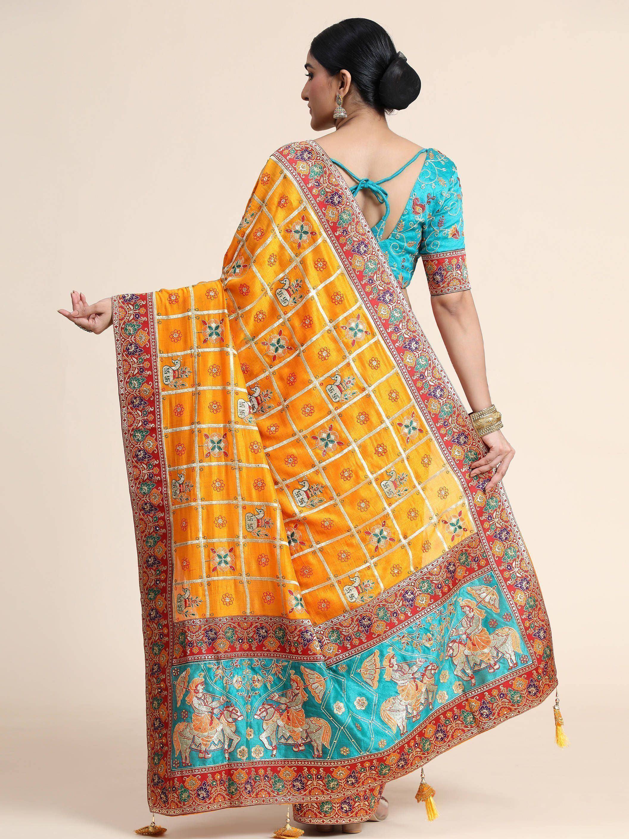 Yellow and turquoise embroidered saree with floral and figurative motifs, paired with matching blouse