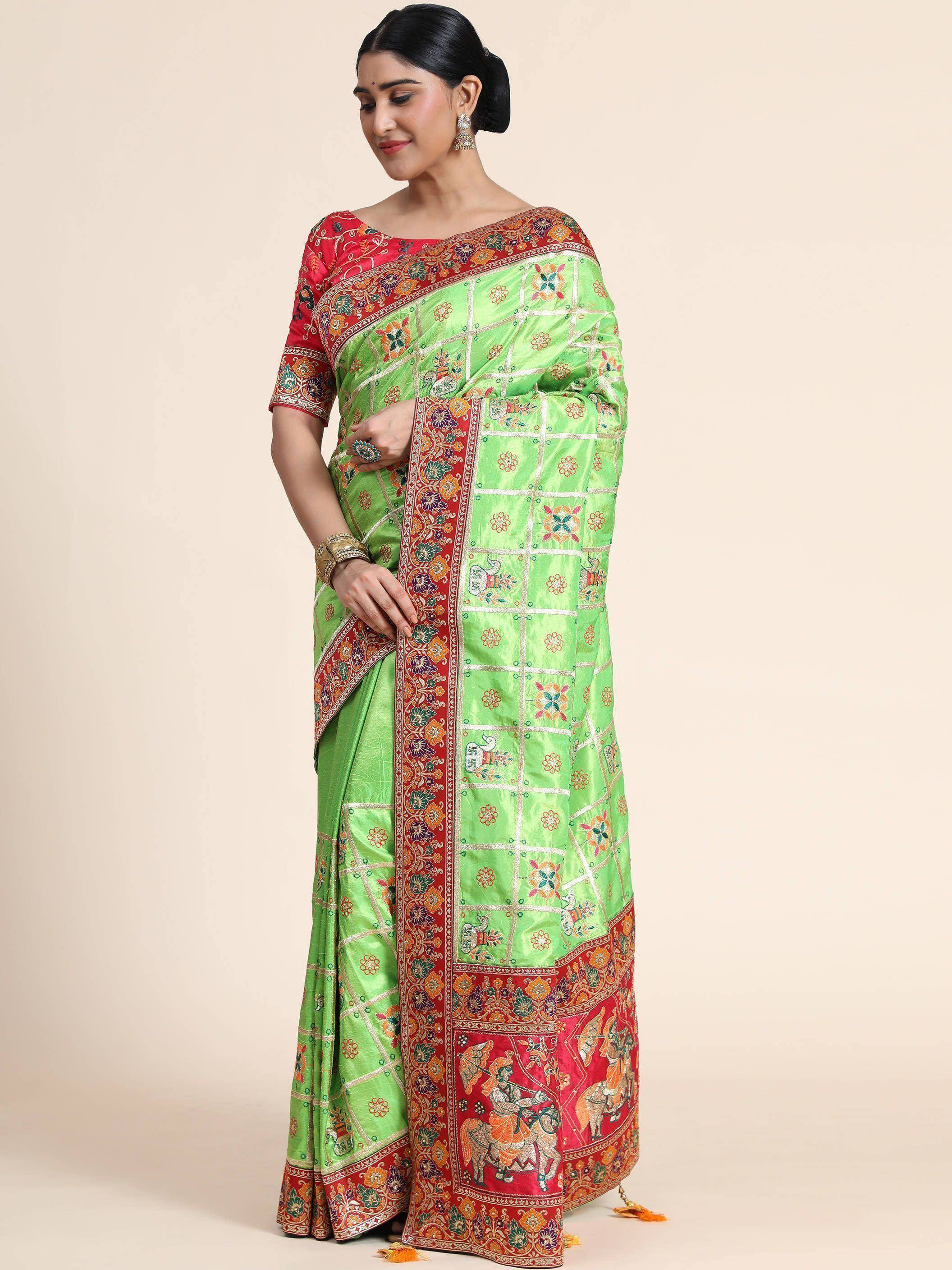 Green and red embroidered Indian saree with floral and elephant motifs, perfect for festive occasions.