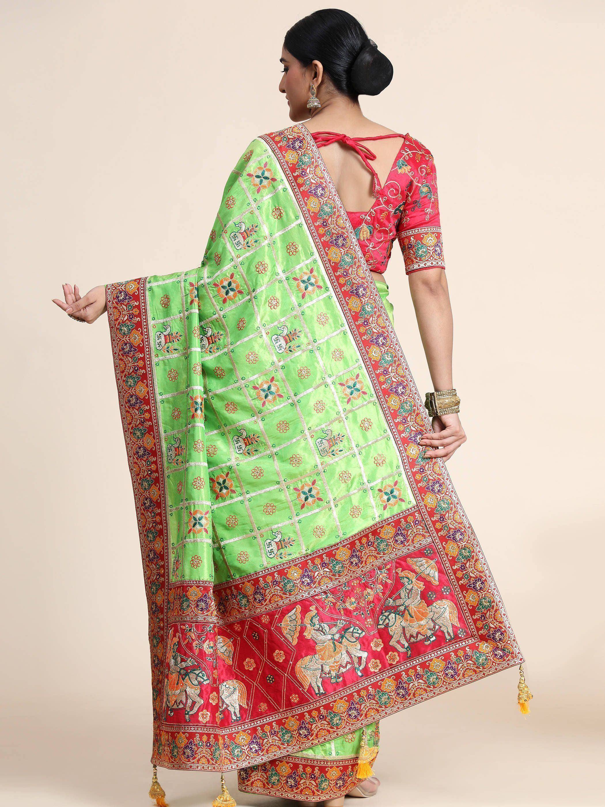 Green and red embroidered saree with elephant motifs and floral border, paired with designer blouse for ethnic wear