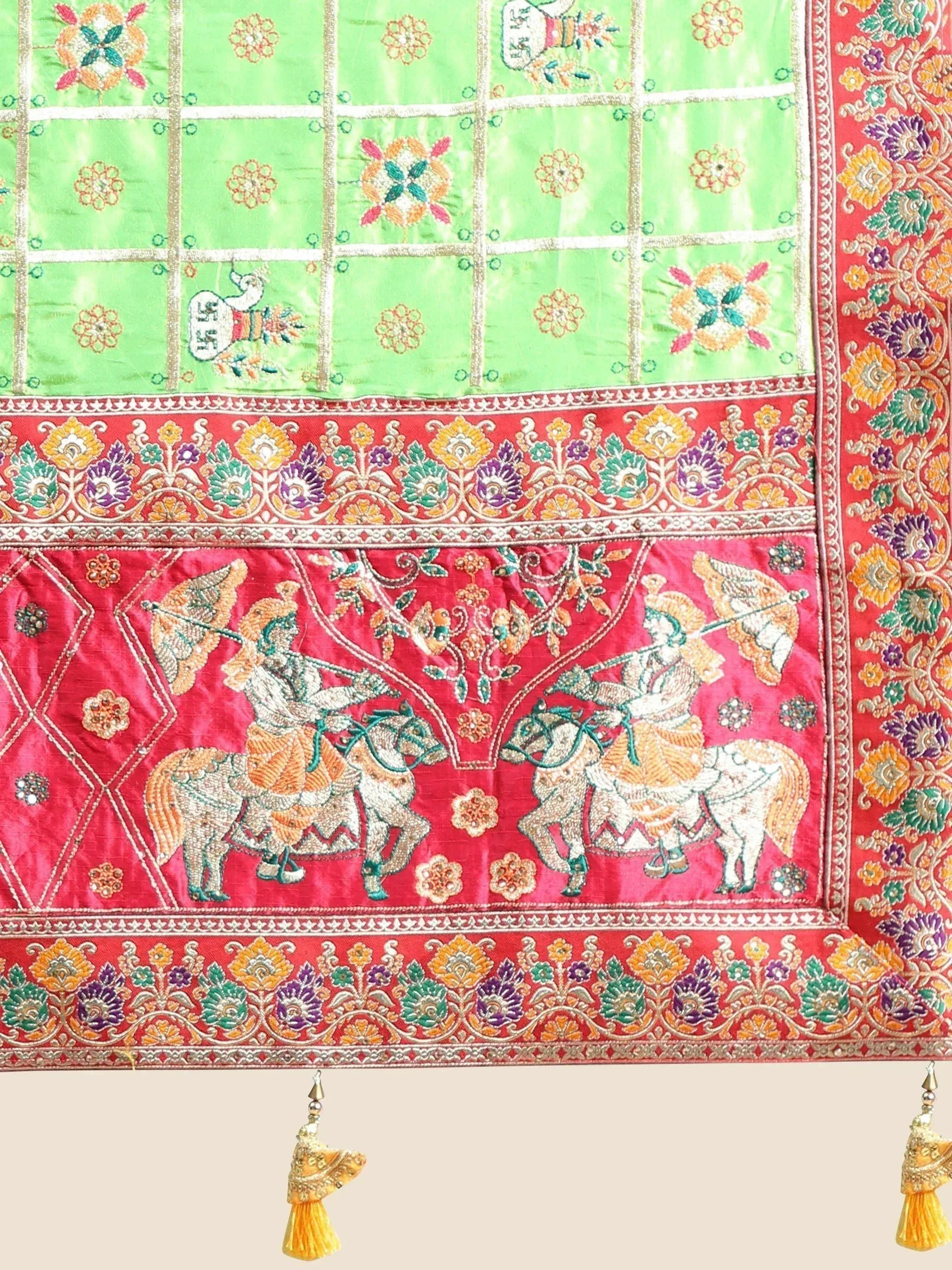 Green and red embroidered Indian saree with horse riders, floral motifs, and tassels for ethnic wear