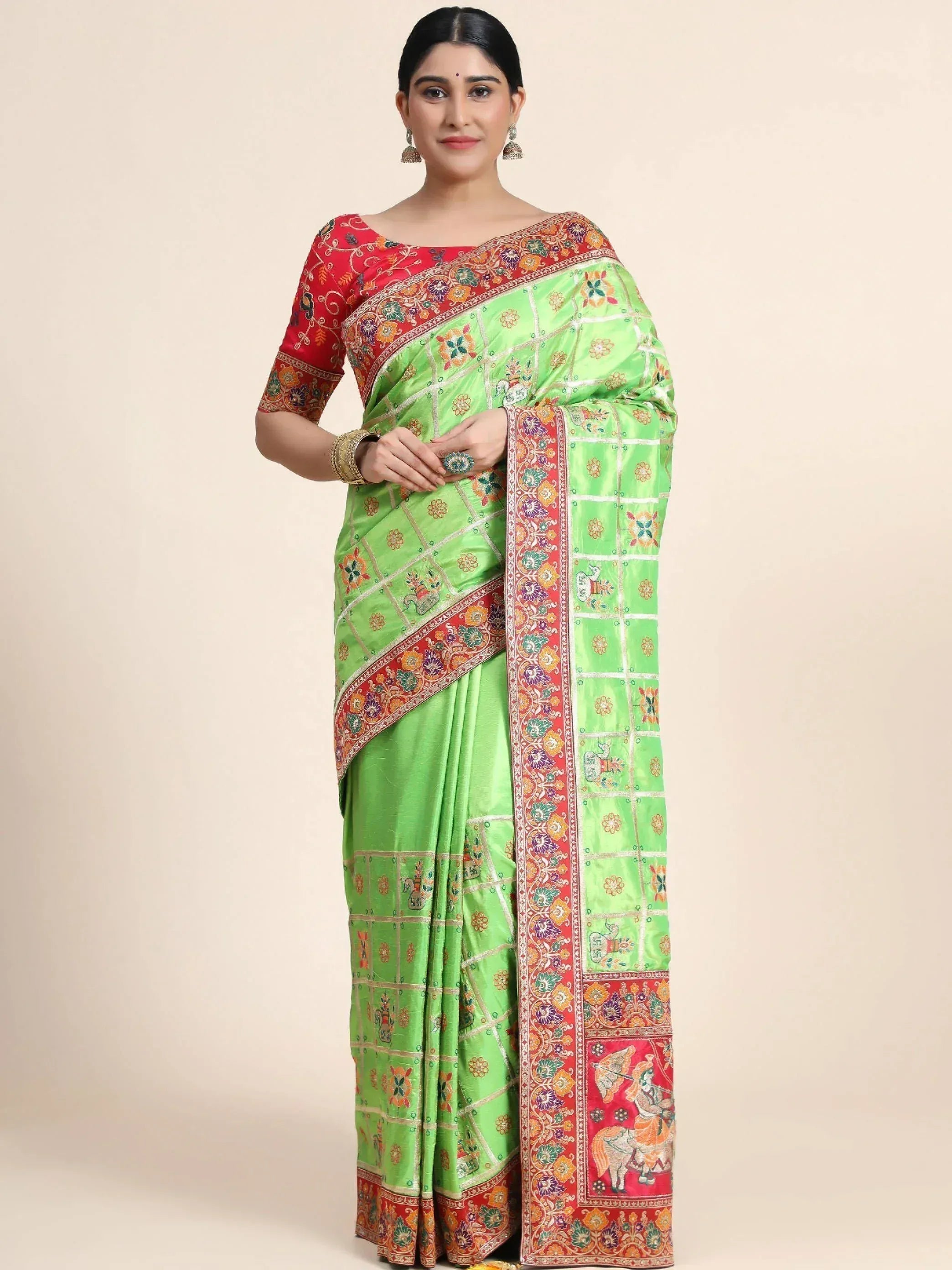 Green and red embroidered saree with floral and elephant motifs, perfect for Indian ethnic wear occasions