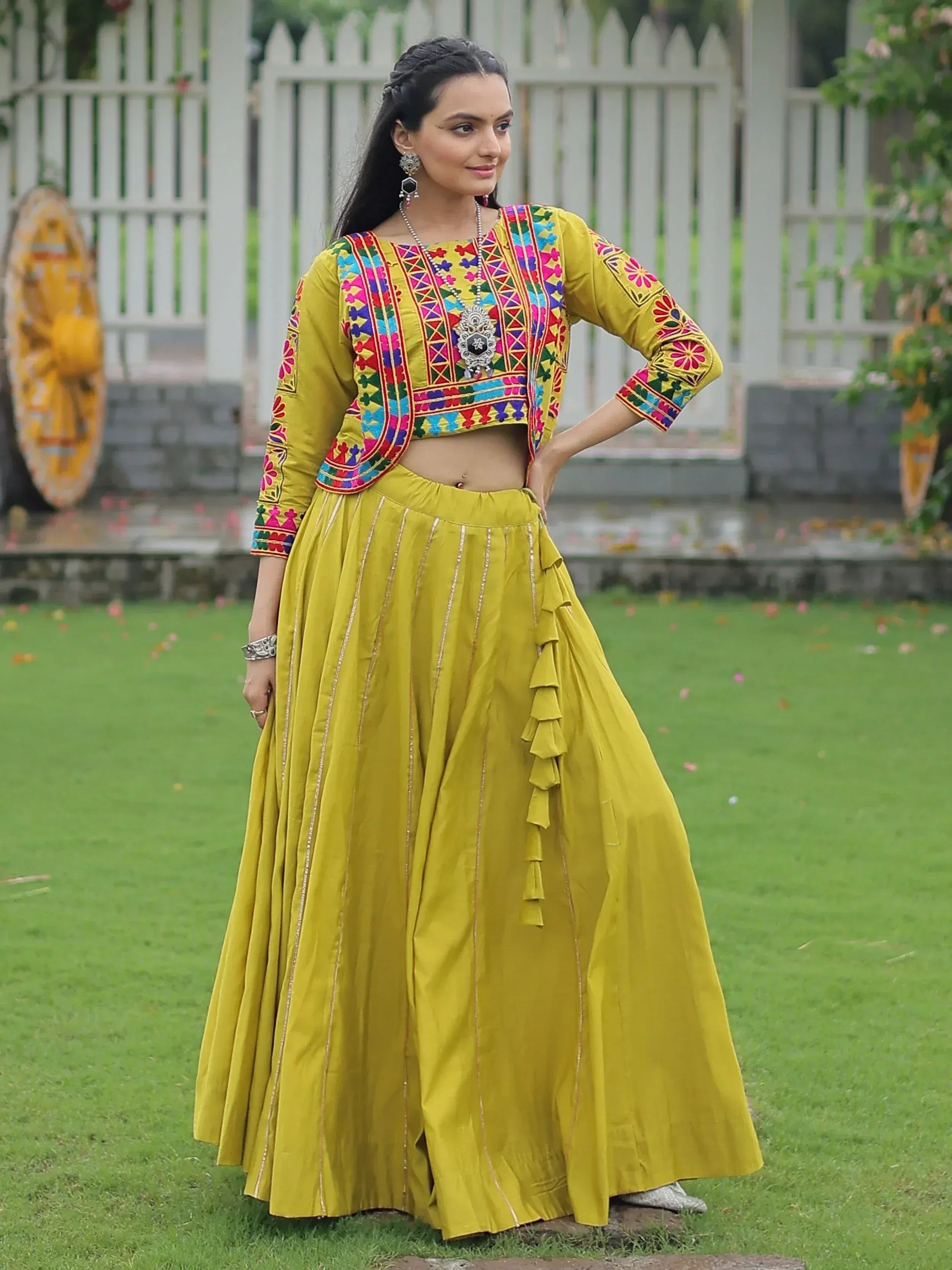 Yellow embroidered lehenga choli with colorful mirror work, perfect for Indian ethnic wear