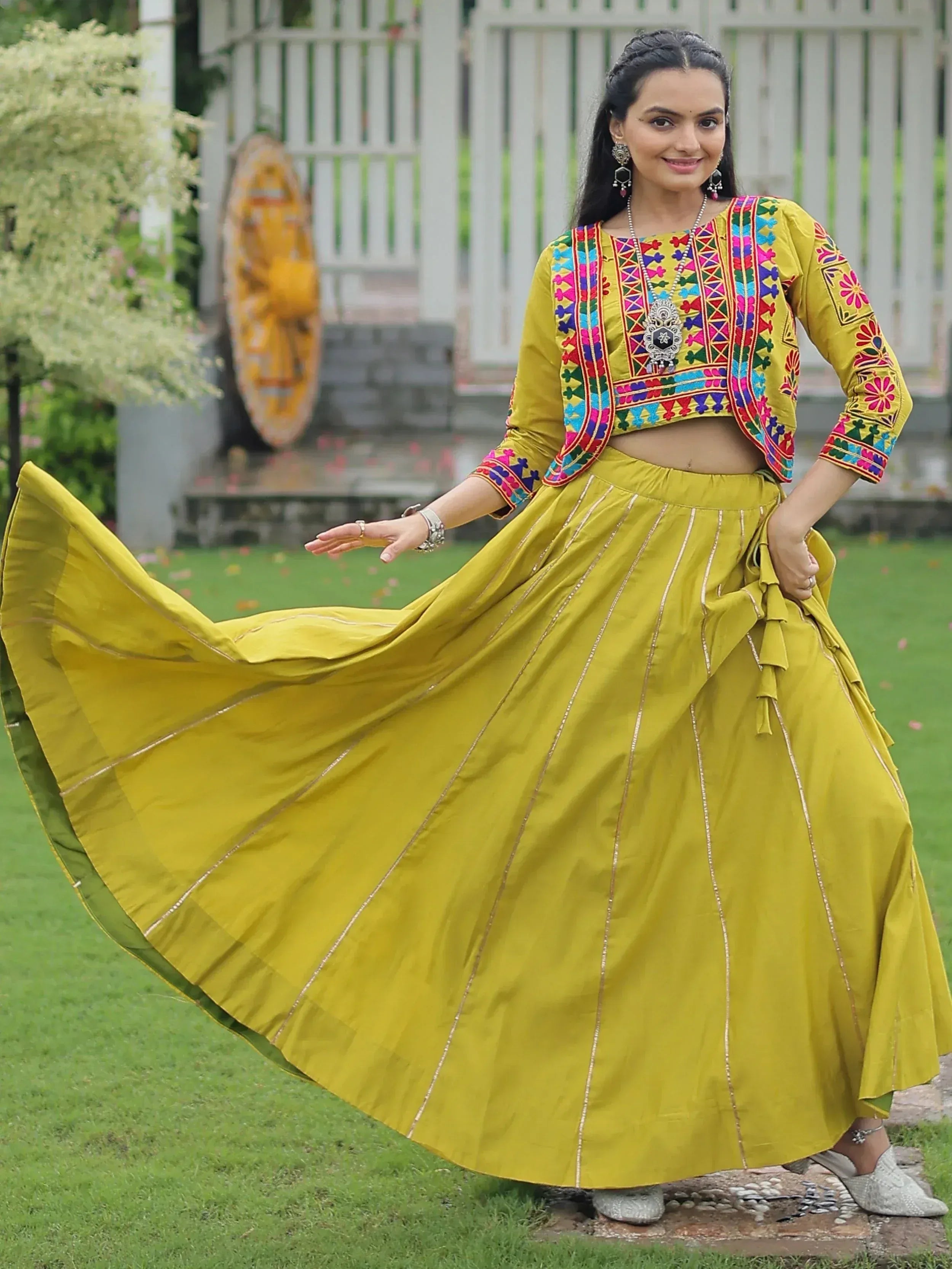 Yellow embroidered lehenga choli with colorful mirror work, perfect for Indian ethnic wear