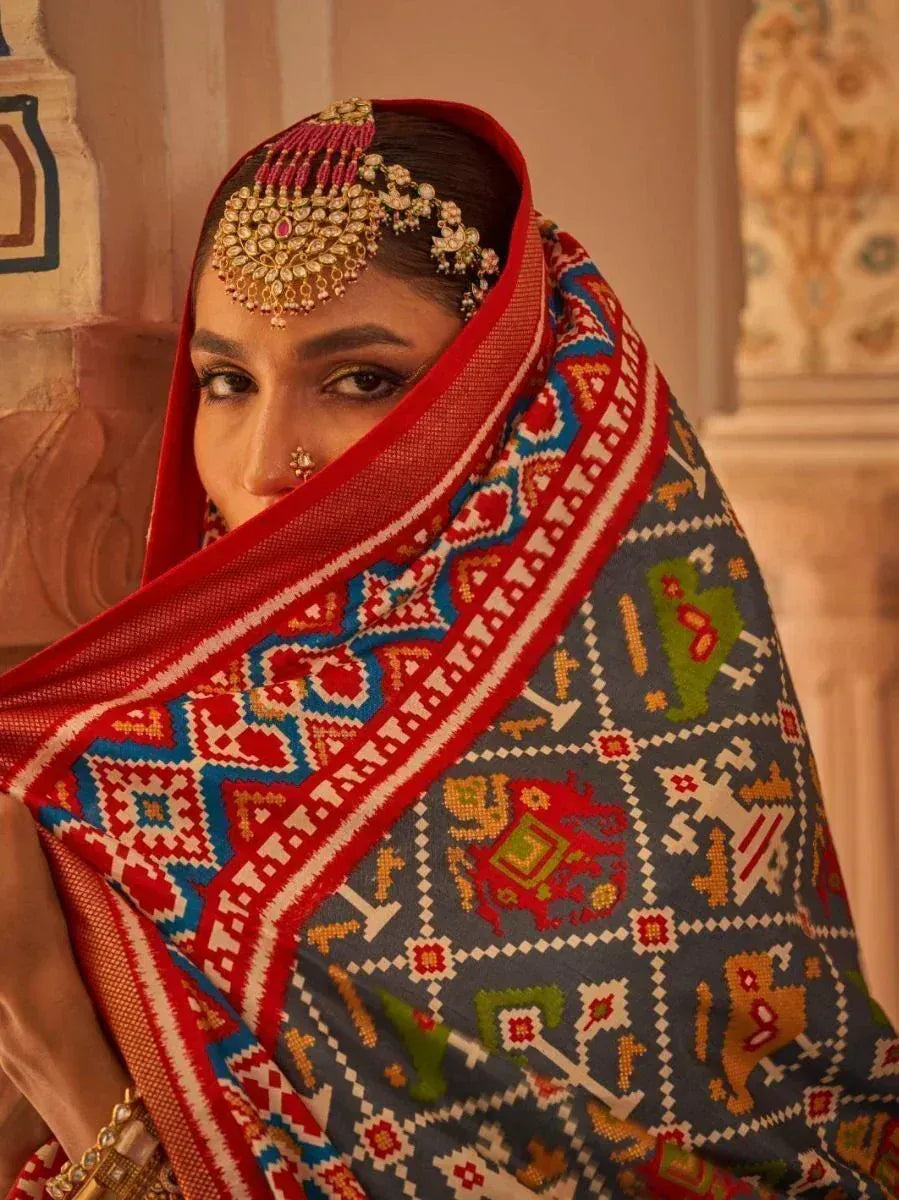 Woman in traditional Indian ethnic wear with embroidered dupatta and maang tikka, perfect for festive occasions