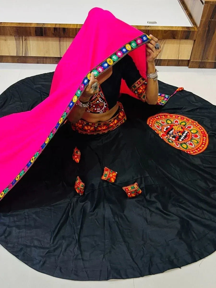 Black embroidered lehenga choli with vibrant pink dupatta, ethnic Indian wear for festive occasions