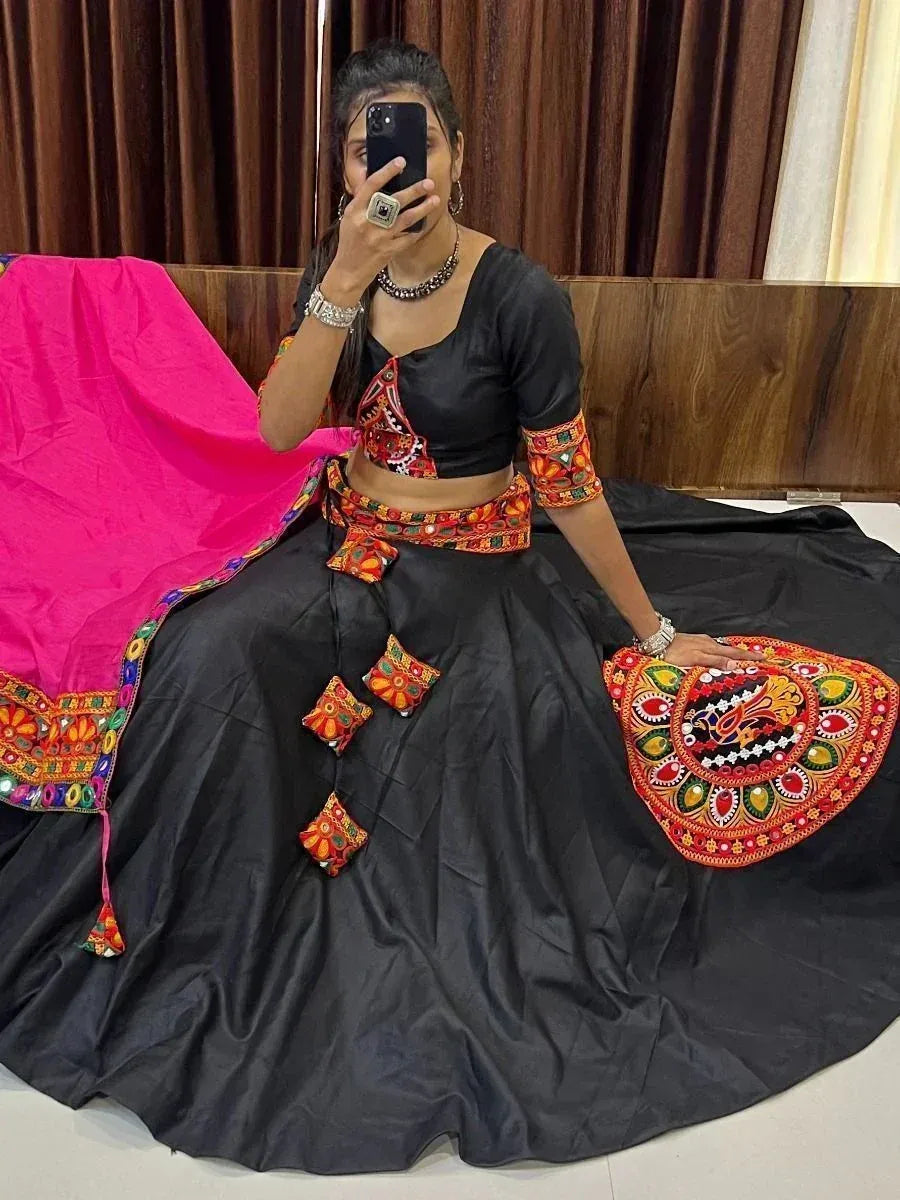 Black ethnic lehenga choli with vibrant mirror work and pink dupatta, perfect for festive occasions
