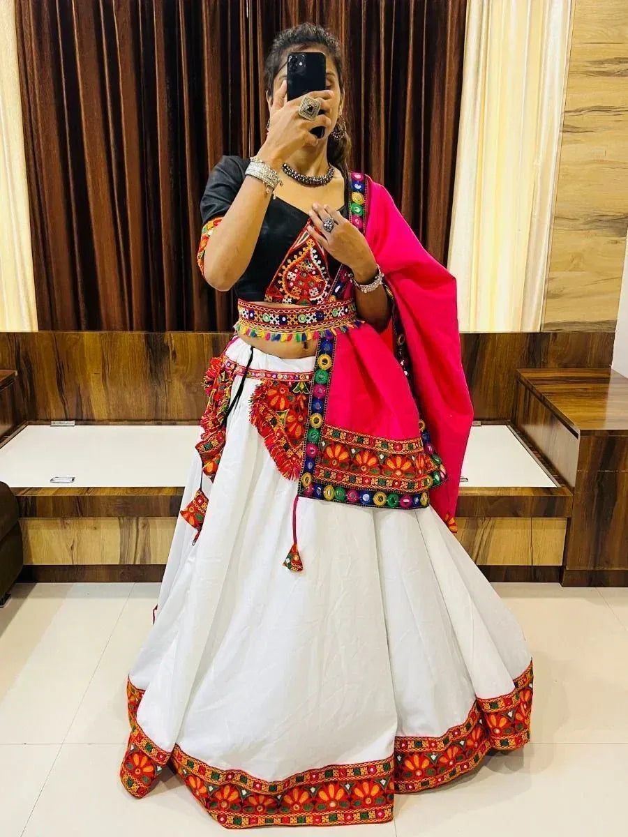 Woman in white embroidered lehenga with black blouse and pink dupatta, traditional Indian ethnic wear