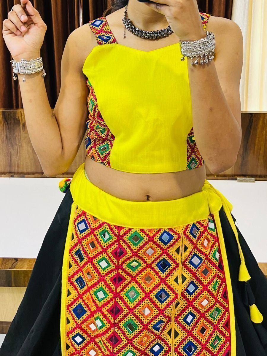 Vibrant yellow crop top with mirror work paired with black skirt, ethnic Indian wear