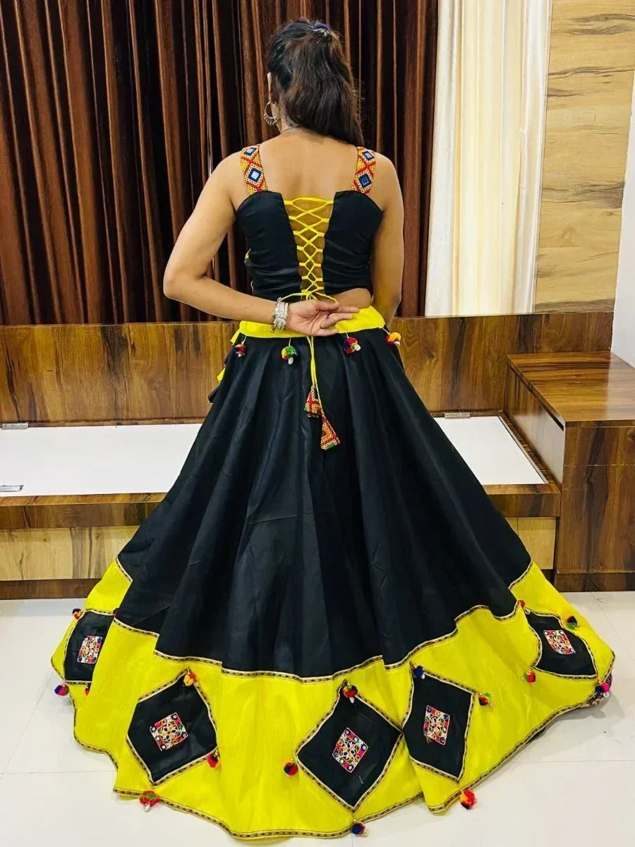 Black and yellow ethnic lehenga choli with lace-up back and mirror work, perfect for Indian festivals and weddings