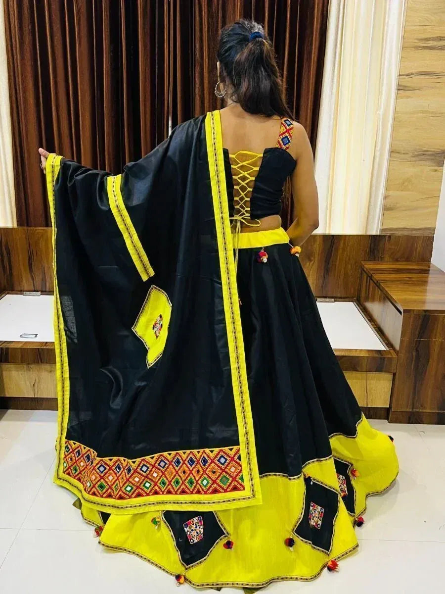 Black and yellow ethnic lehenga choli with mirror work and lace-up back, perfect for festive occasions