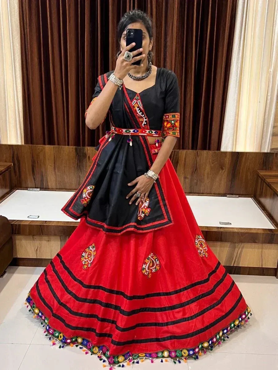 Black and red ethnic lehenga choli with mirror work and tassels, perfect for Indian celebrations