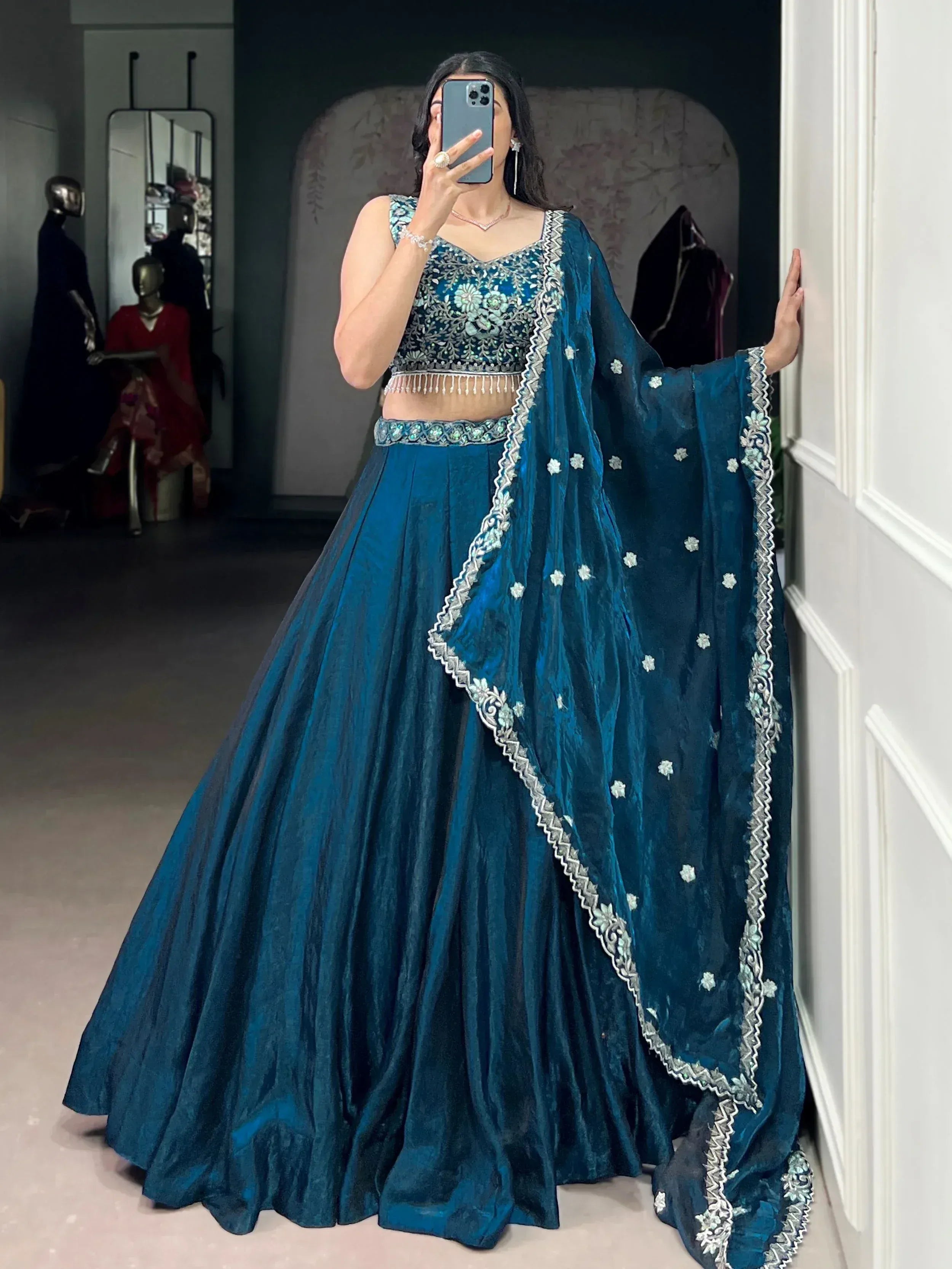 Teal blue embroidered lehenga choli with velvet skirt and floral dupatta, perfect for Indian weddings and festive occasions