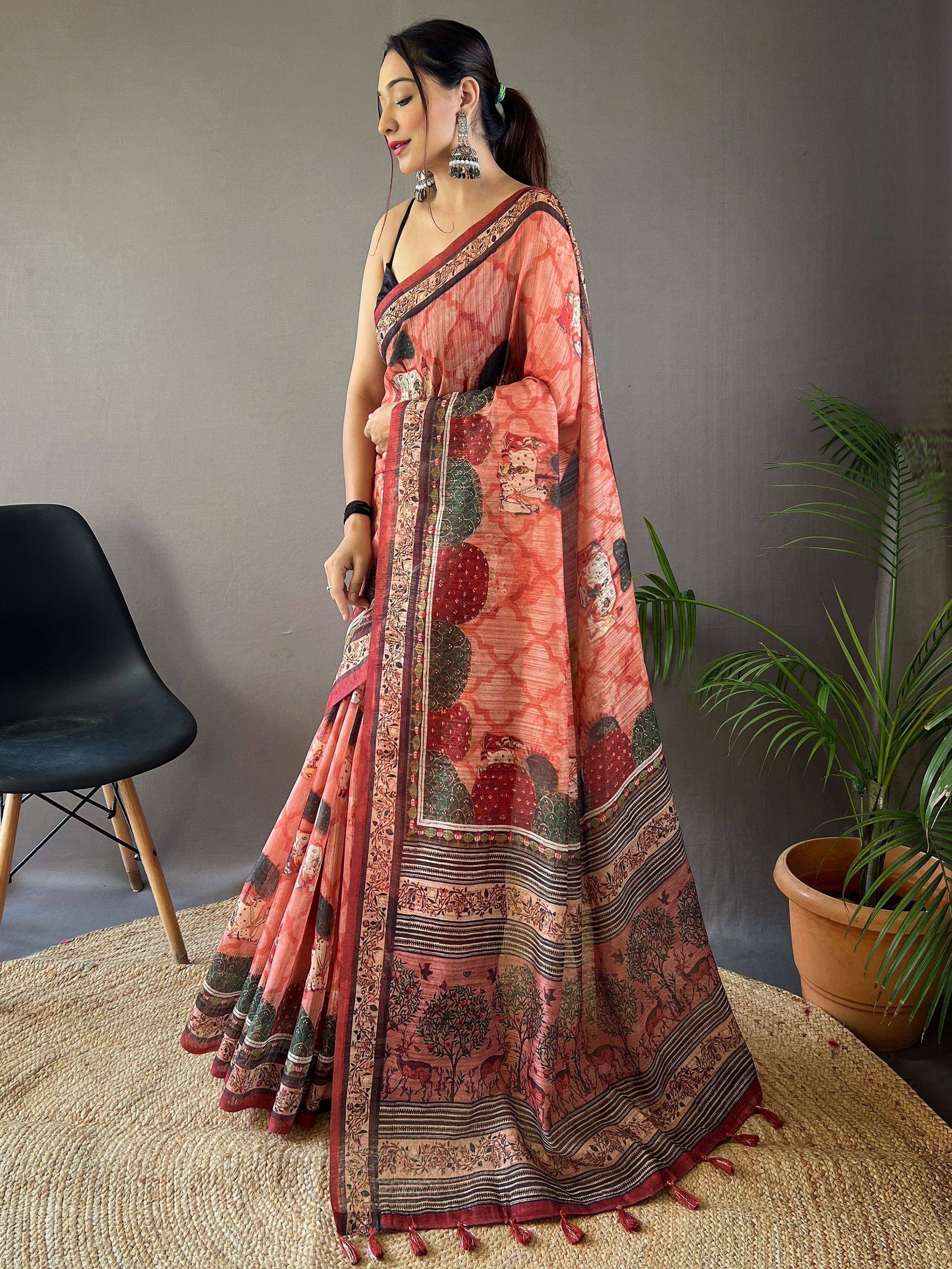 Woman wearing printed ethnic saree with tassels, traditional Indian attire for festive occasions