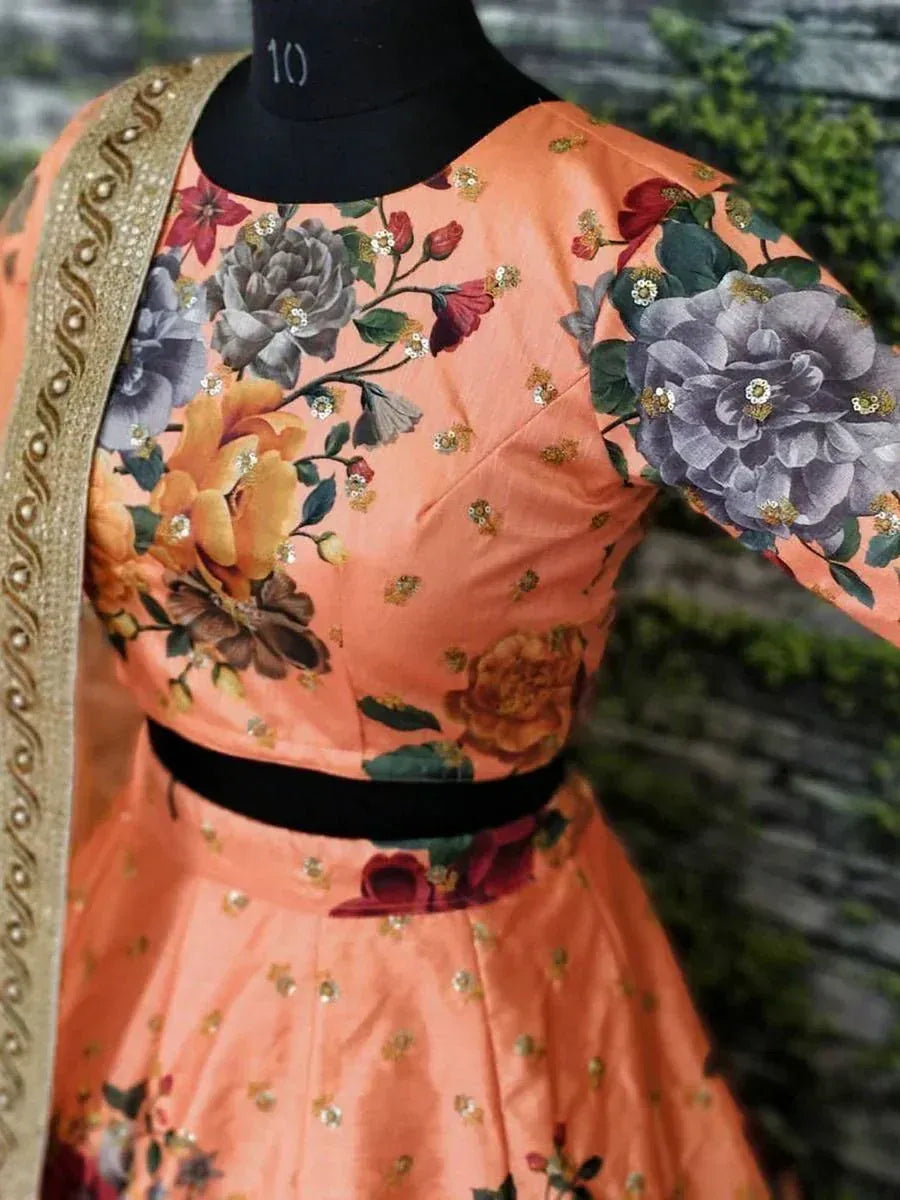 Peach floral print lehenga choli with gold embroidery and black waistband, perfect for Indian ethnic wear