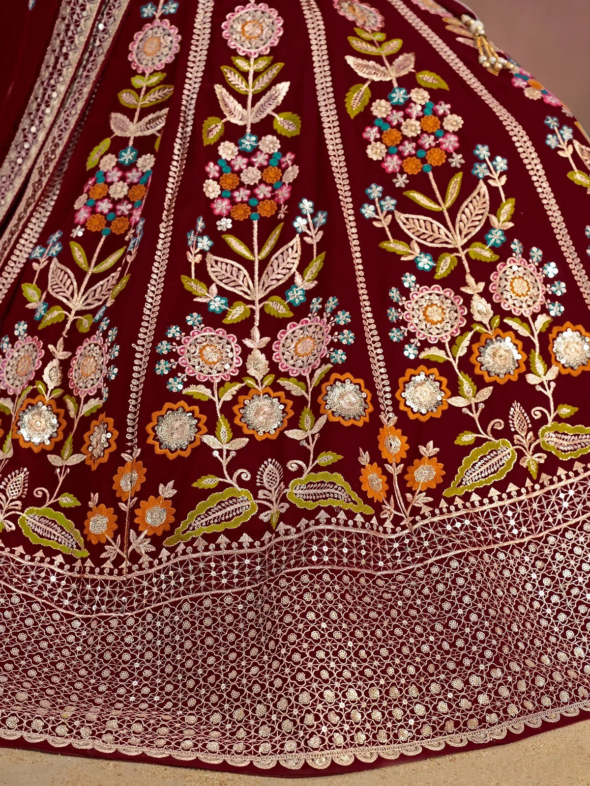 Maroon lehenga with intricate floral embroidery and sequin work, perfect for Indian ethnic wear.
