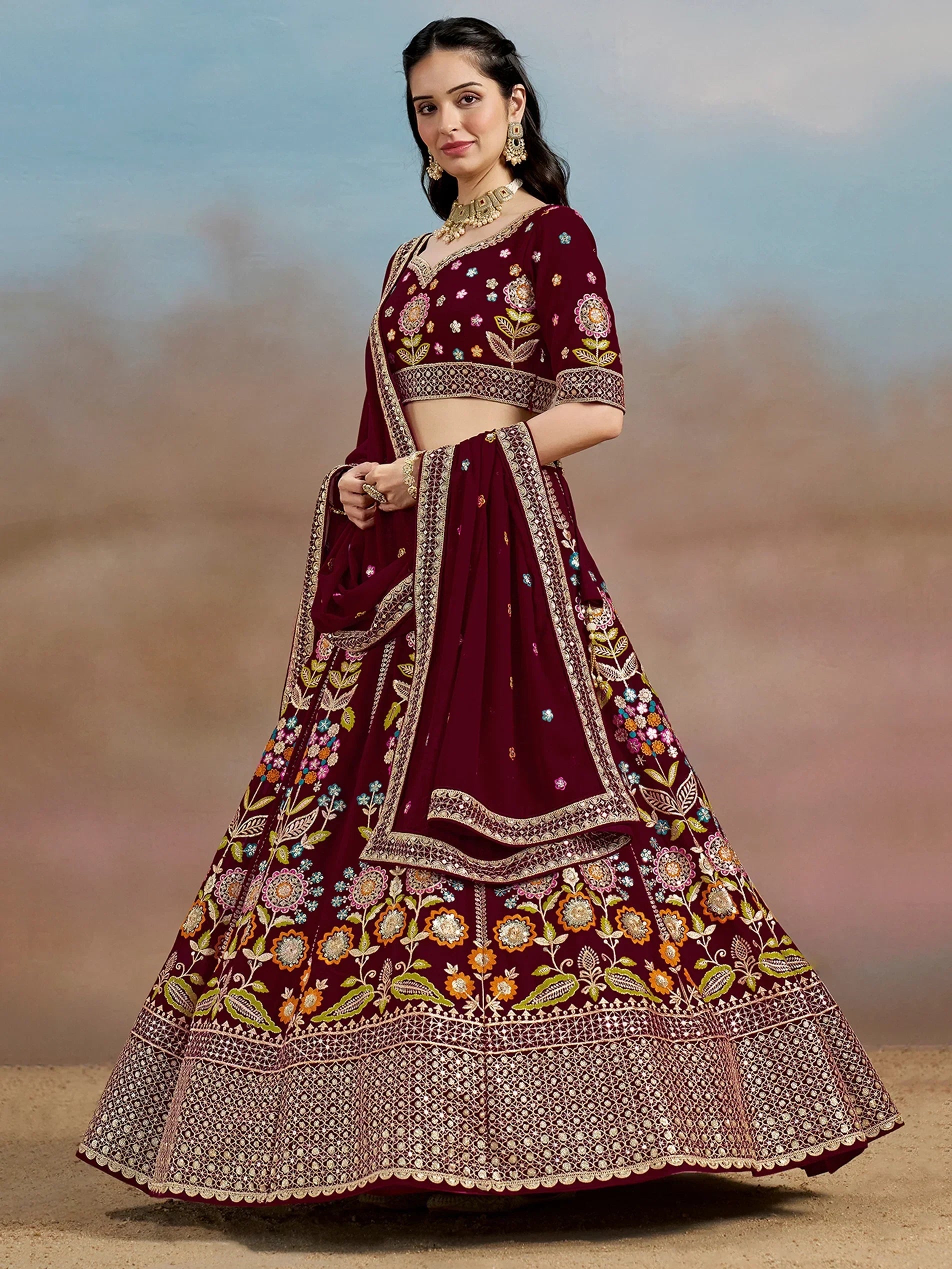 Maroon floral embroidered lehenga choli with gold detailing, perfect for Indian weddings and festive occasions