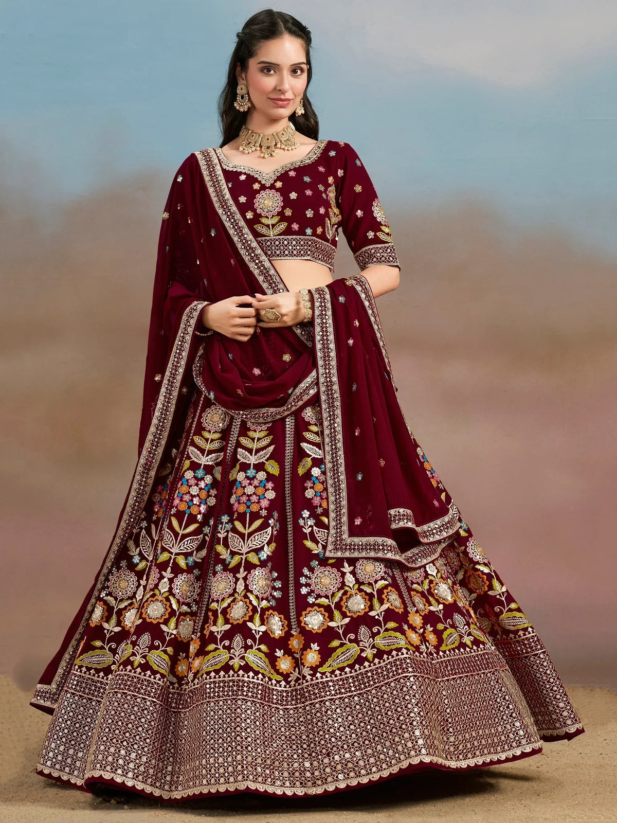 Maroon embroidered lehenga choli with floral motifs and gold detailing, perfect for Indian weddings and festive occasions.