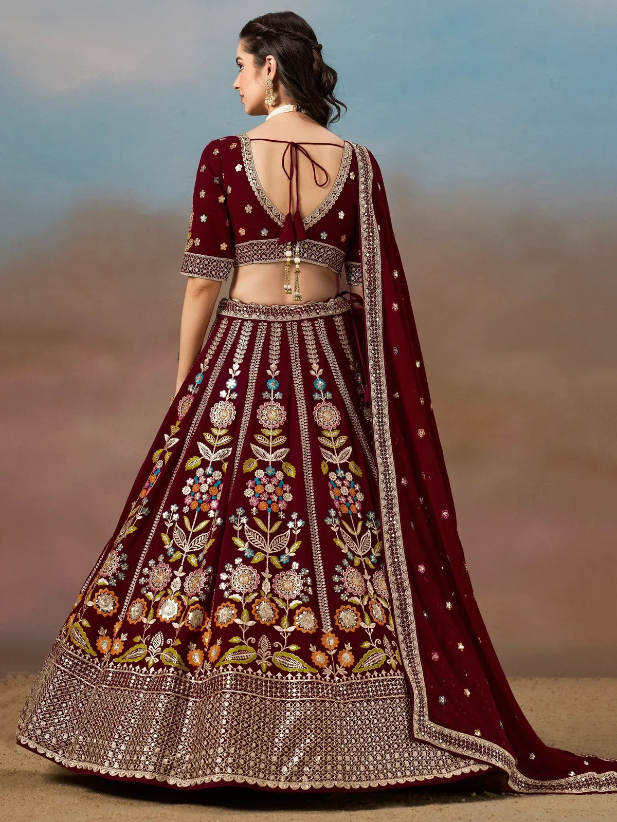 Maroon embroidered lehenga choli with floral motifs and back tie design, perfect for Indian ethnic wear