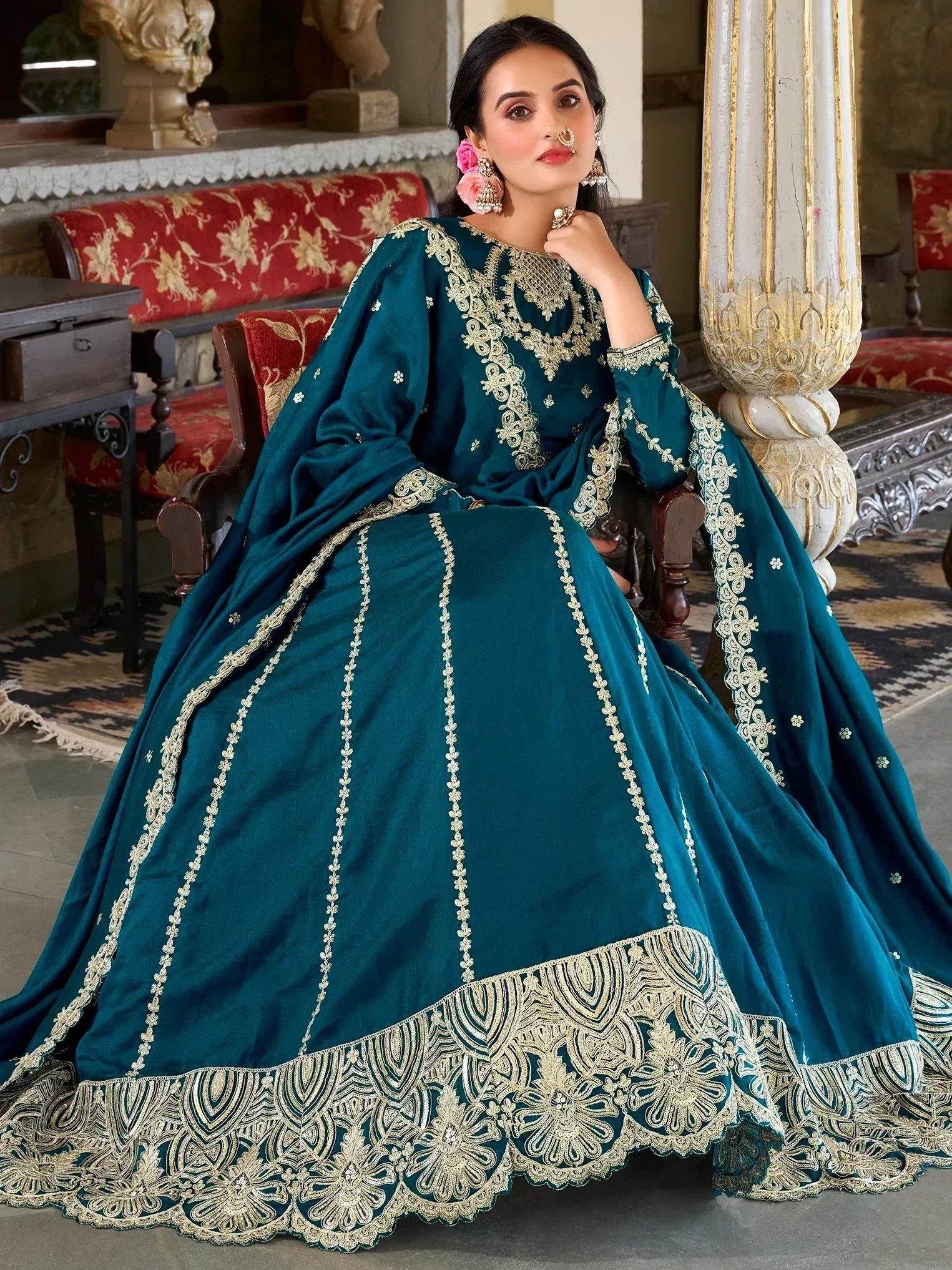 Teal velvet designer lehenga choli with gold embroidery, perfect for Indian weddings and festive occasions.