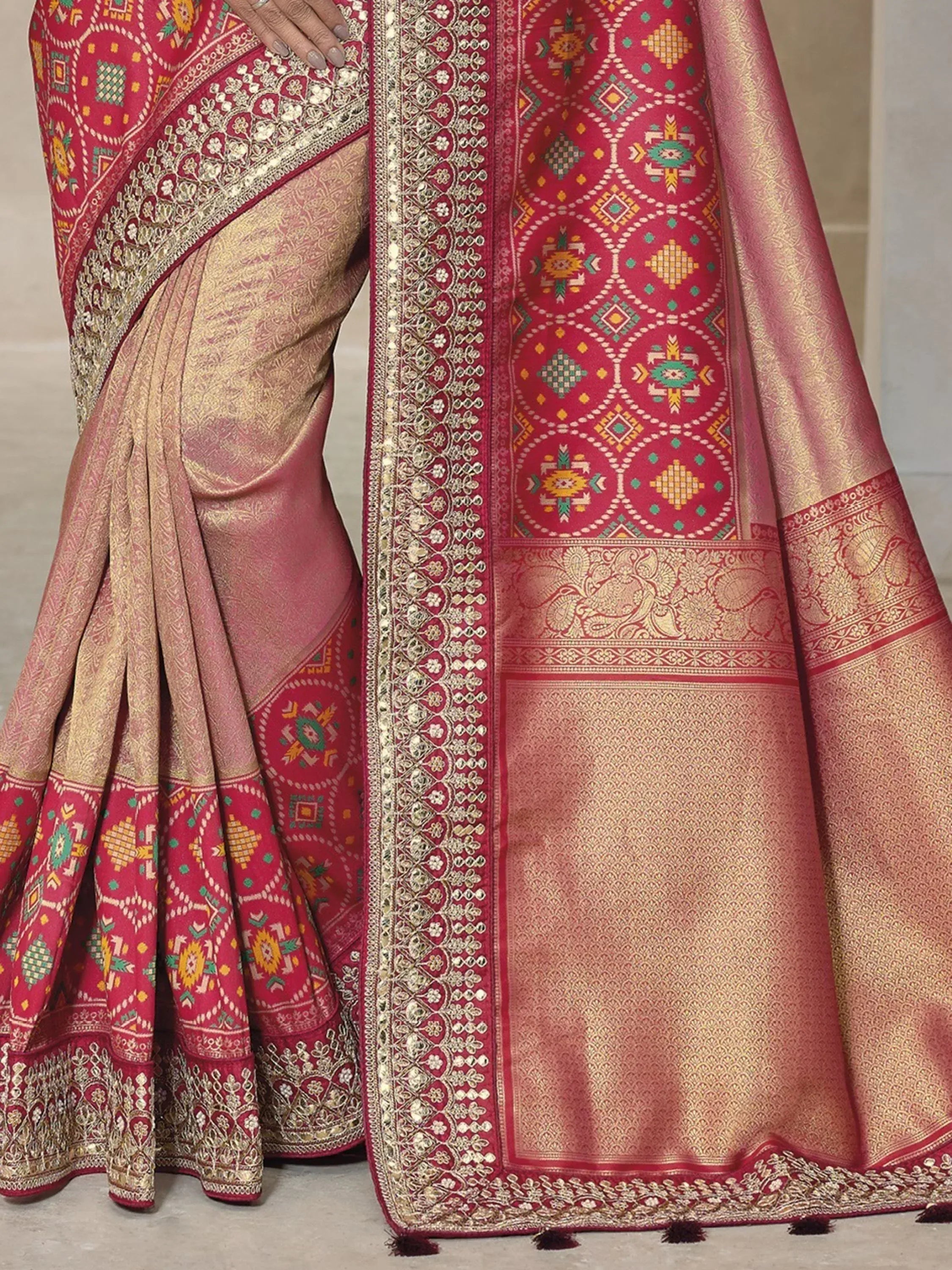 Elegant pink and gold ethnic saree with intricate geometric and floral embroidery, perfect for festive occasions.
