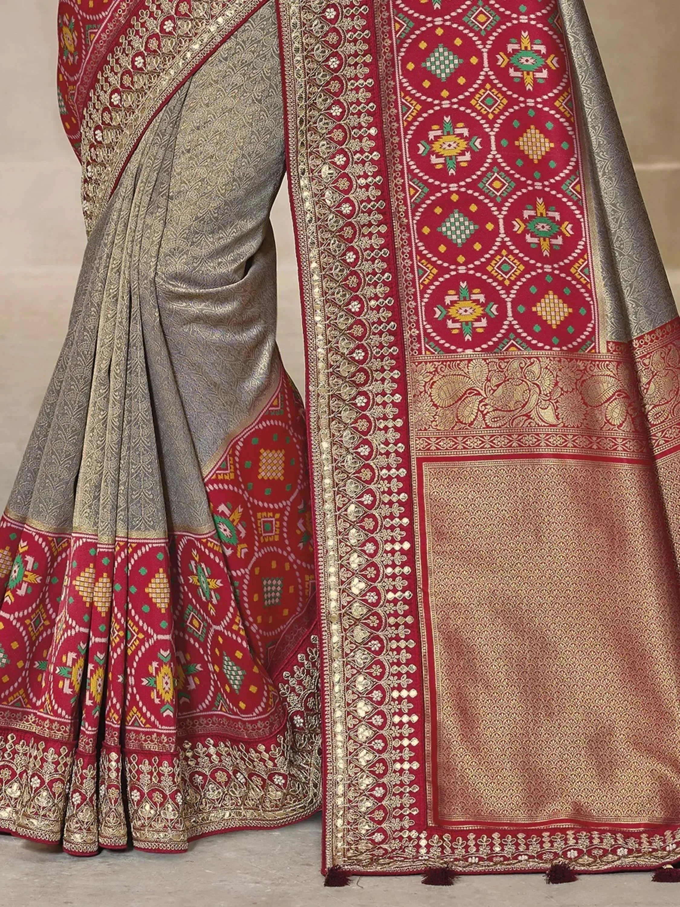 Grey and red ethnic saree with intricate geometric and floral embroidery, perfect for Indian festive occasions.