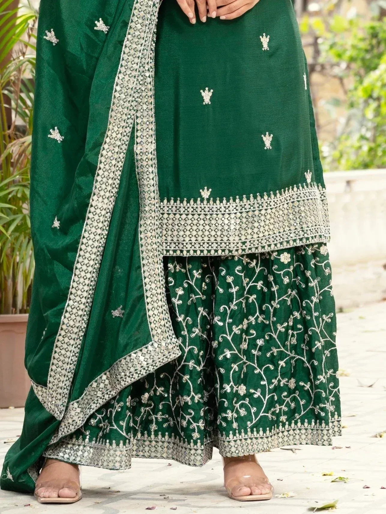 Emerald green embroidered salwar kameez with floral motifs and silver border, perfect for ethnic occasions.