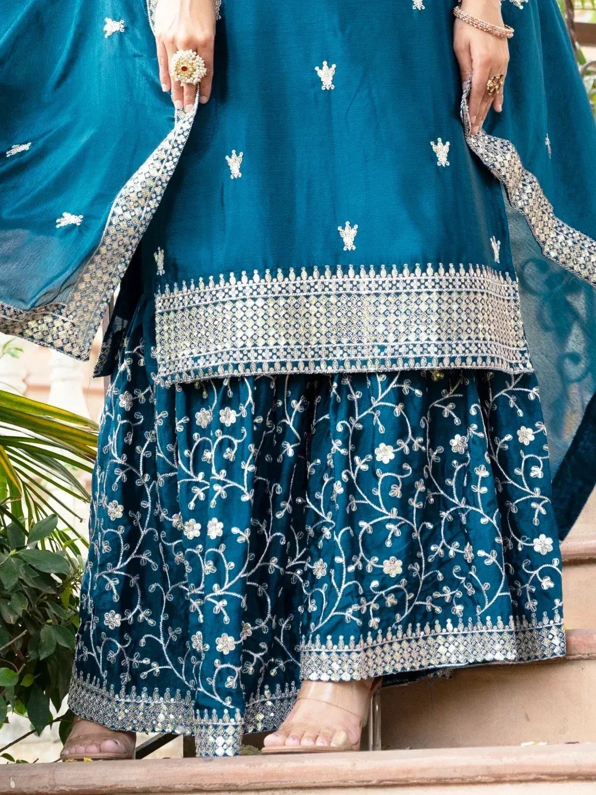 Teal embroidered lehenga choli with floral motifs and silver detailing, perfect for Indian ethnic wear occasions.