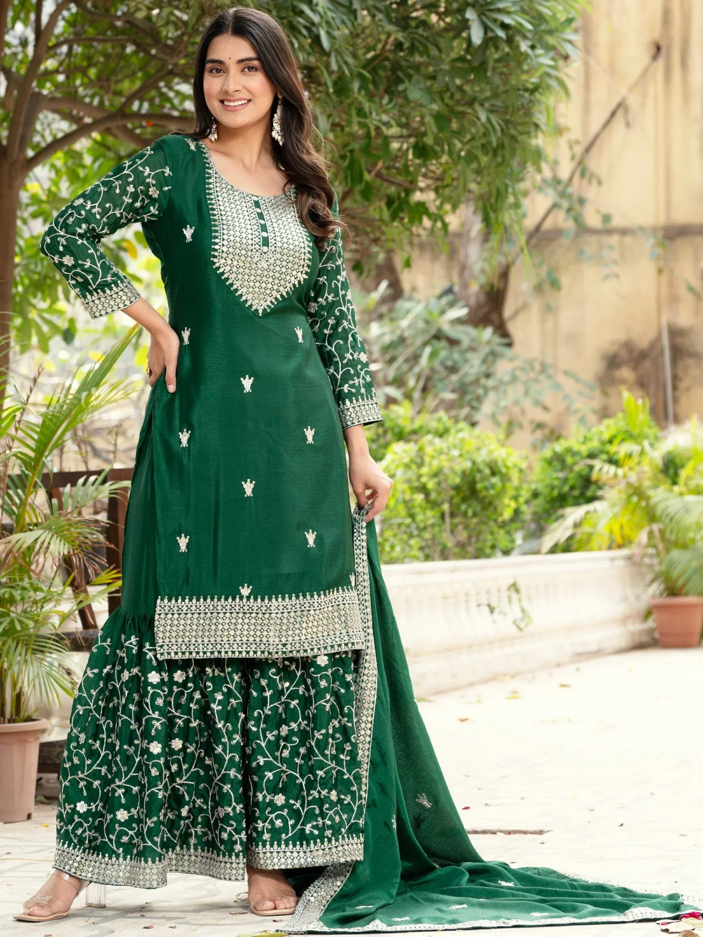 Emerald green embroidered salwar kameez with floral motifs and dupatta, perfect for Indian ethnic occasions.