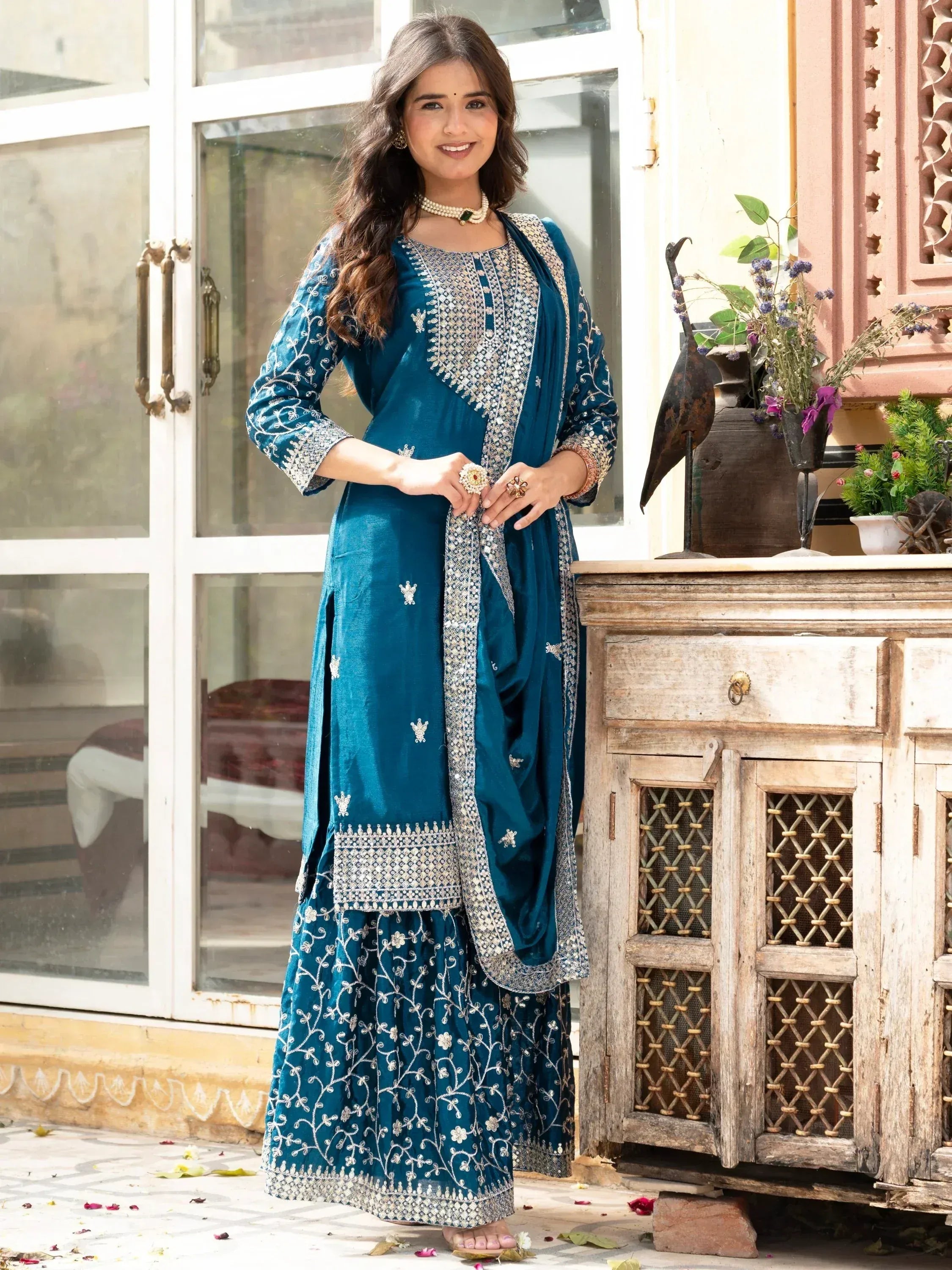 Teal embroidered ethnic suit with floral motifs, perfect for Indian occasions and festive wear.