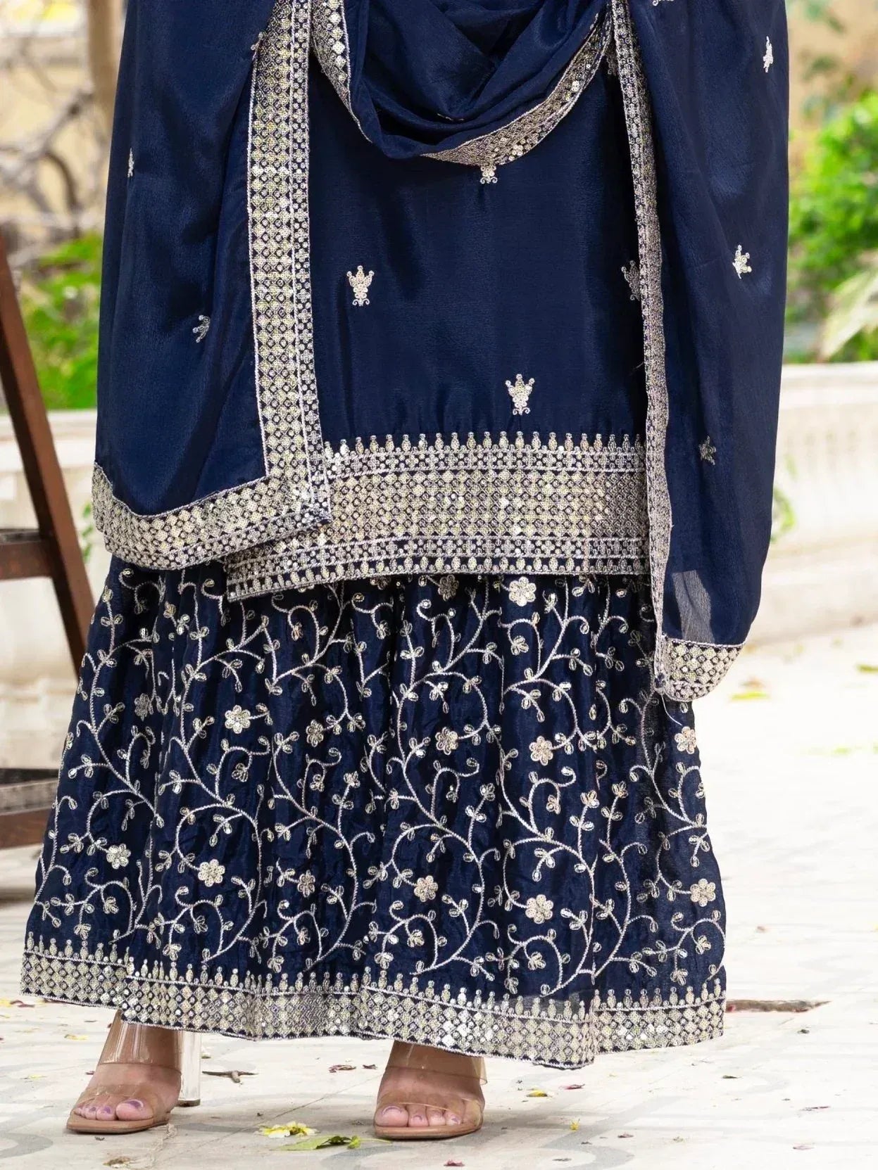 Navy blue embroidered salwar kameez with floral detailing and silver border, perfect for ethnic occasions