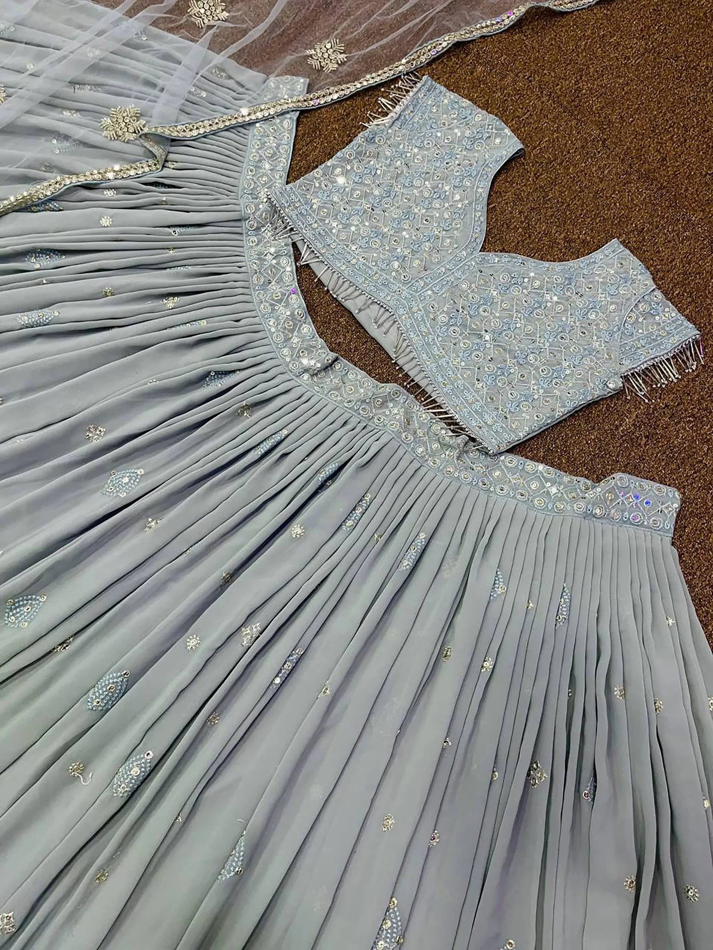 Grey designer lehenga choli with intricate embroidery and pleated skirt, perfect for Indian ethnic wear