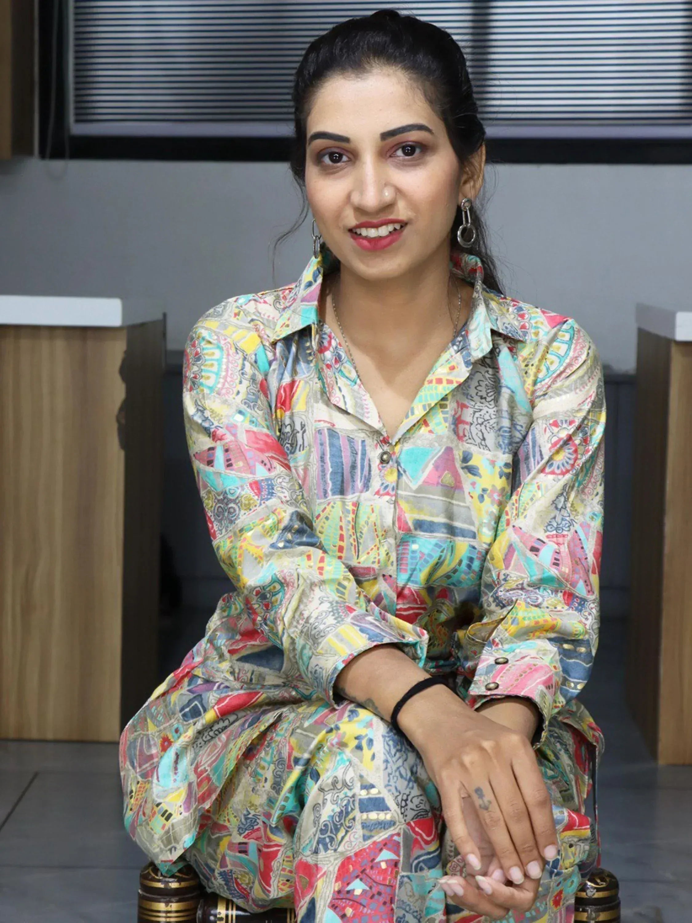 Woman in colorful printed ethnic kurta with geometric patterns, styled for modern Indian fashion