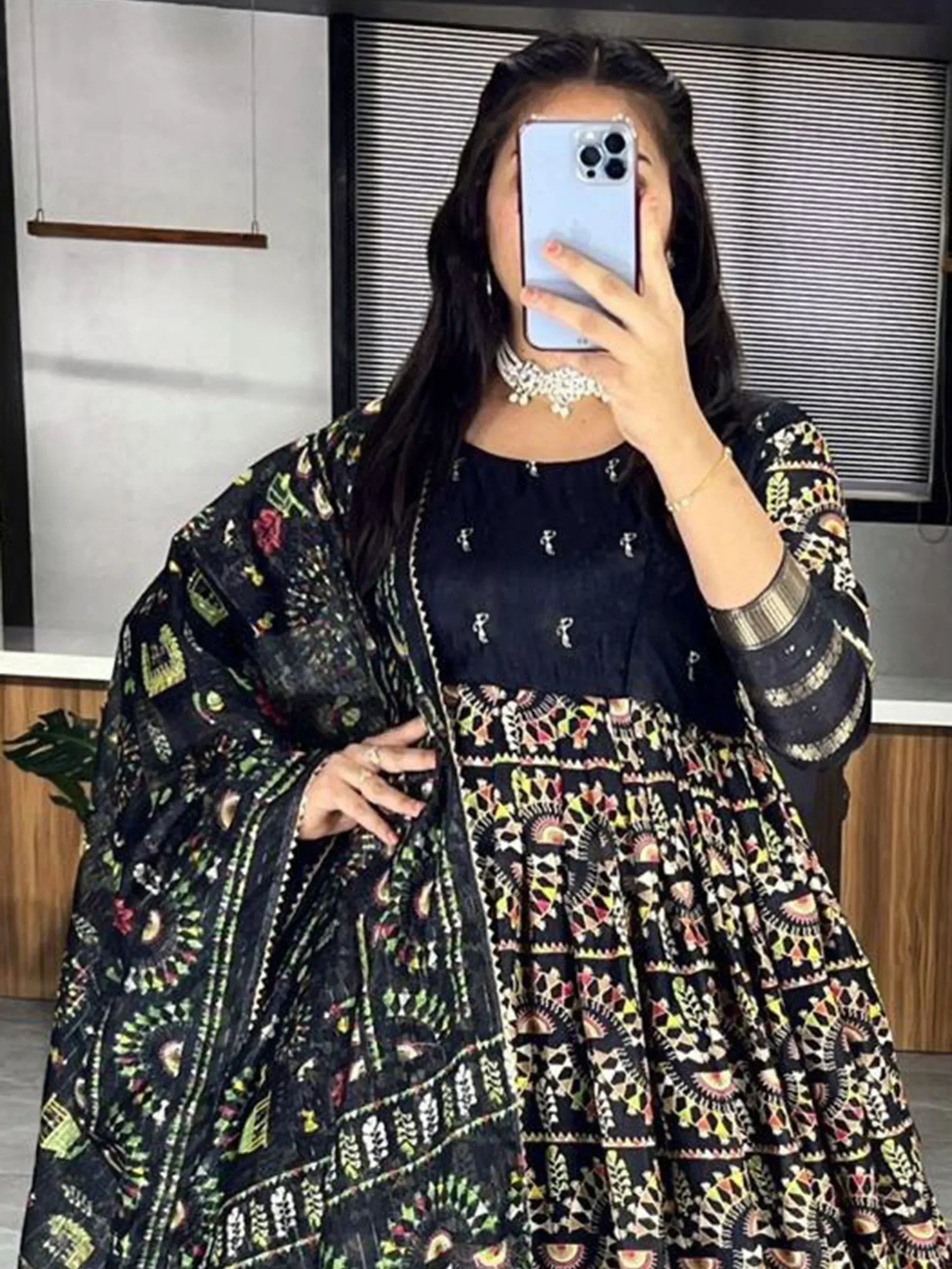 Woman in black printed ethnic gown with matching dupatta, perfect for Indian occasions and festive wear.