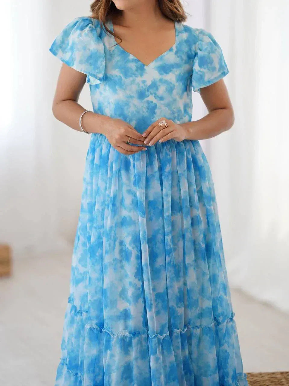 Blue tie-dye ethnic gown with puff sleeves and tiered skirt, perfect for Indian occasions