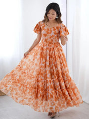Woman wearing orange and white ethnic gown in a bright room, Ethnic Plus fashion