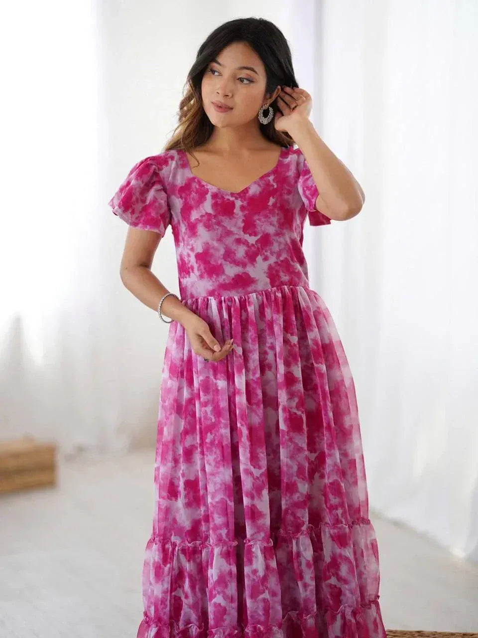 Pink tie-dye ethnic gown with puff sleeves and tiered skirt, perfect for festive occasions