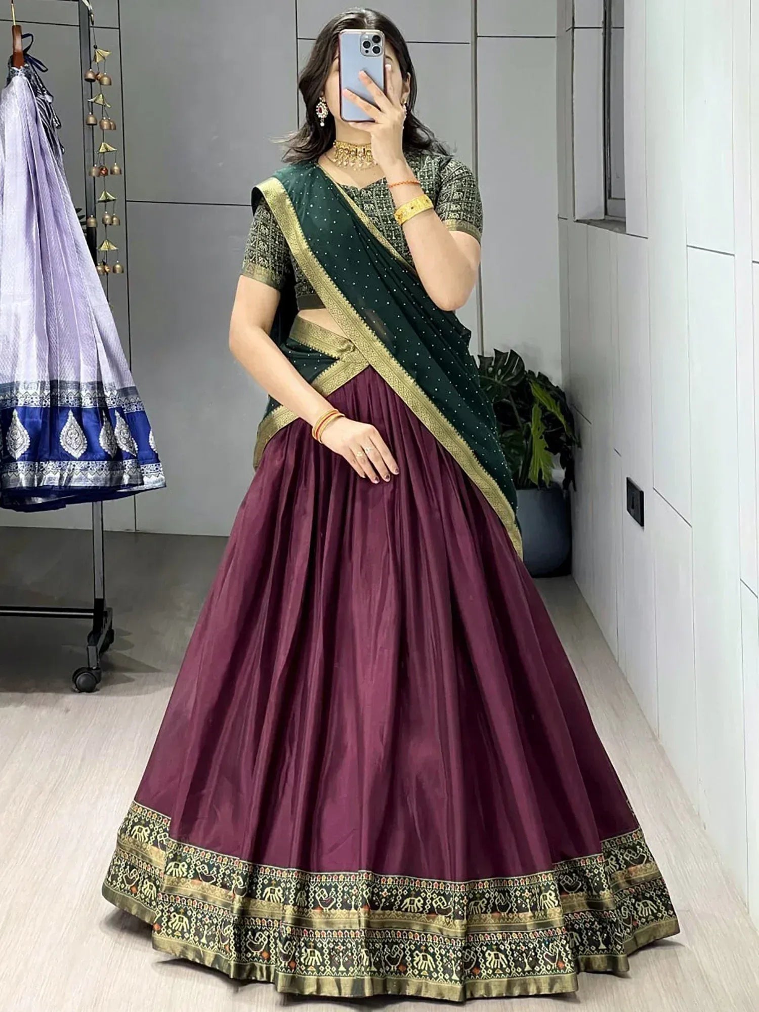 Woman in maroon lehenga choli with green dupatta, ethnic Indian wear for weddings and festivals