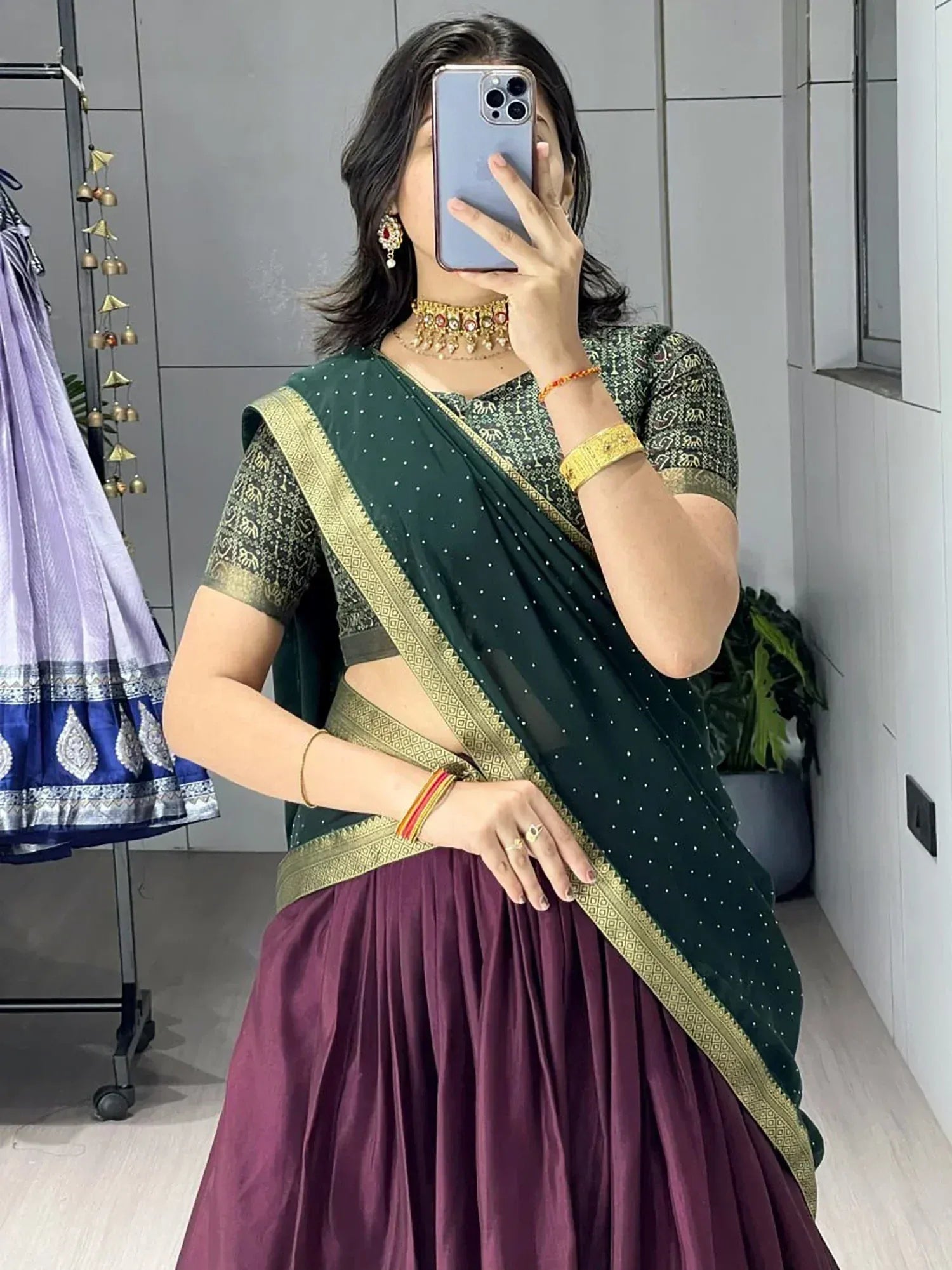 Woman in green and purple Indian saree with gold border, traditional ethnic wear for festive occasions