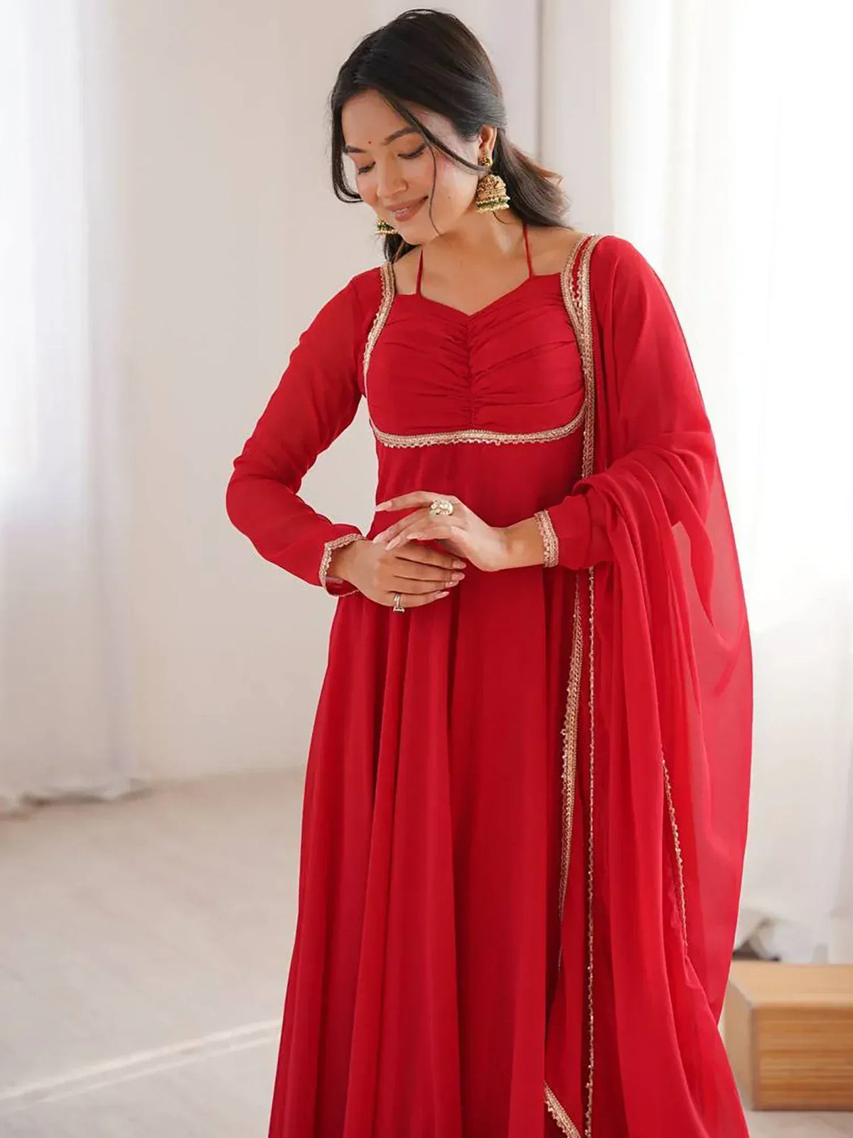 Red ethnic gown with gold embroidery, perfect for Indian weddings and festive occasions