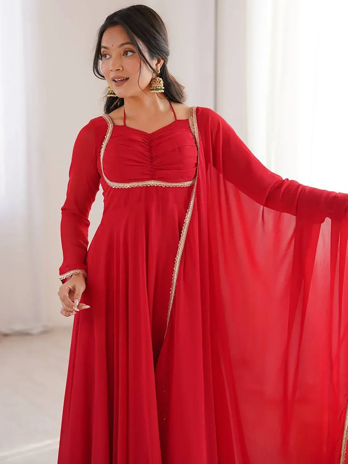 Red ethnic gown with gold trim, perfect for Indian occasions and festive wear