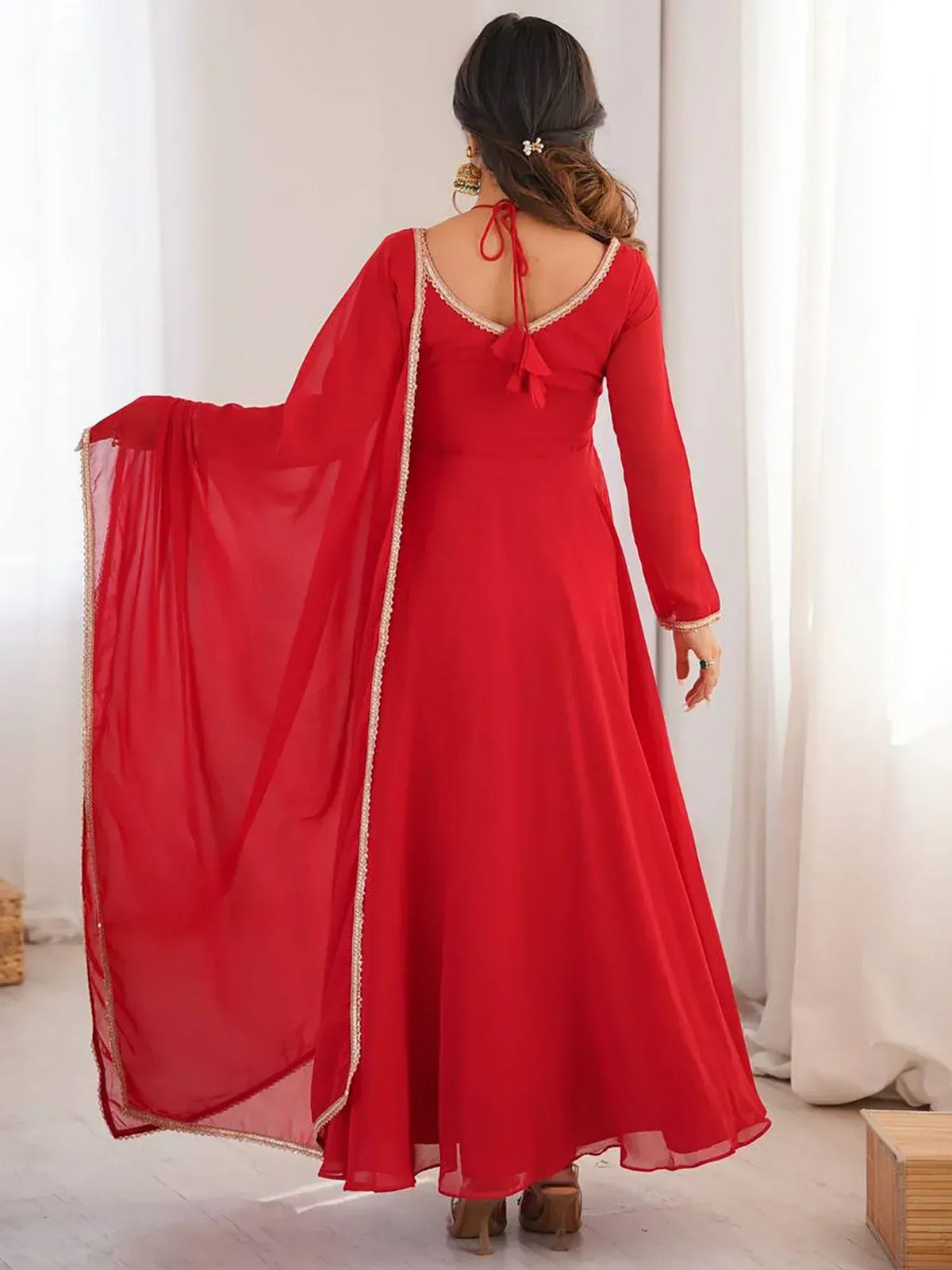 Red ethnic gown with gold trim and sheer dupatta, back view