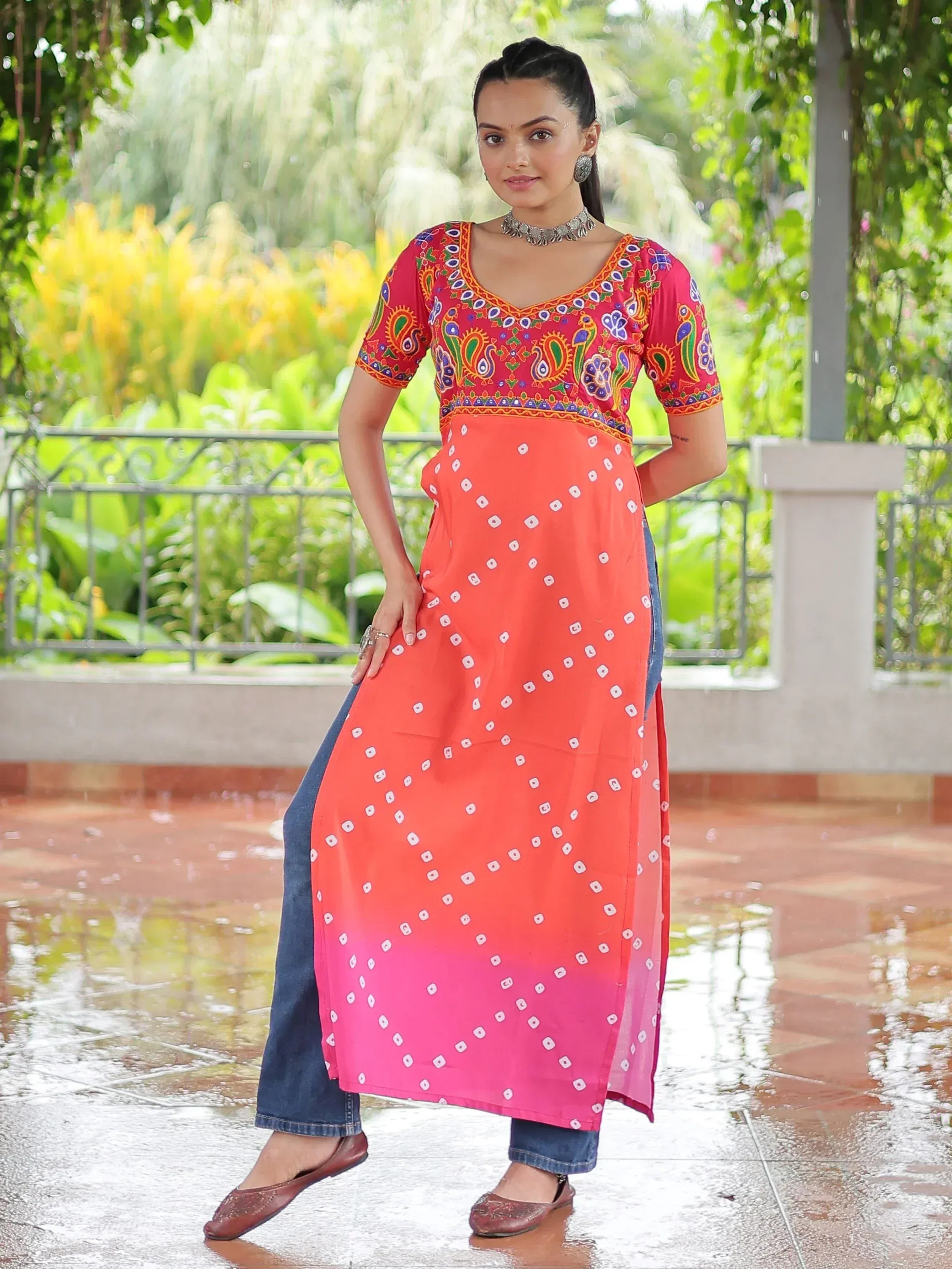 Woman in colorful embroidered kurta with ombre bandhani print, paired with jeans, for ethnic wear