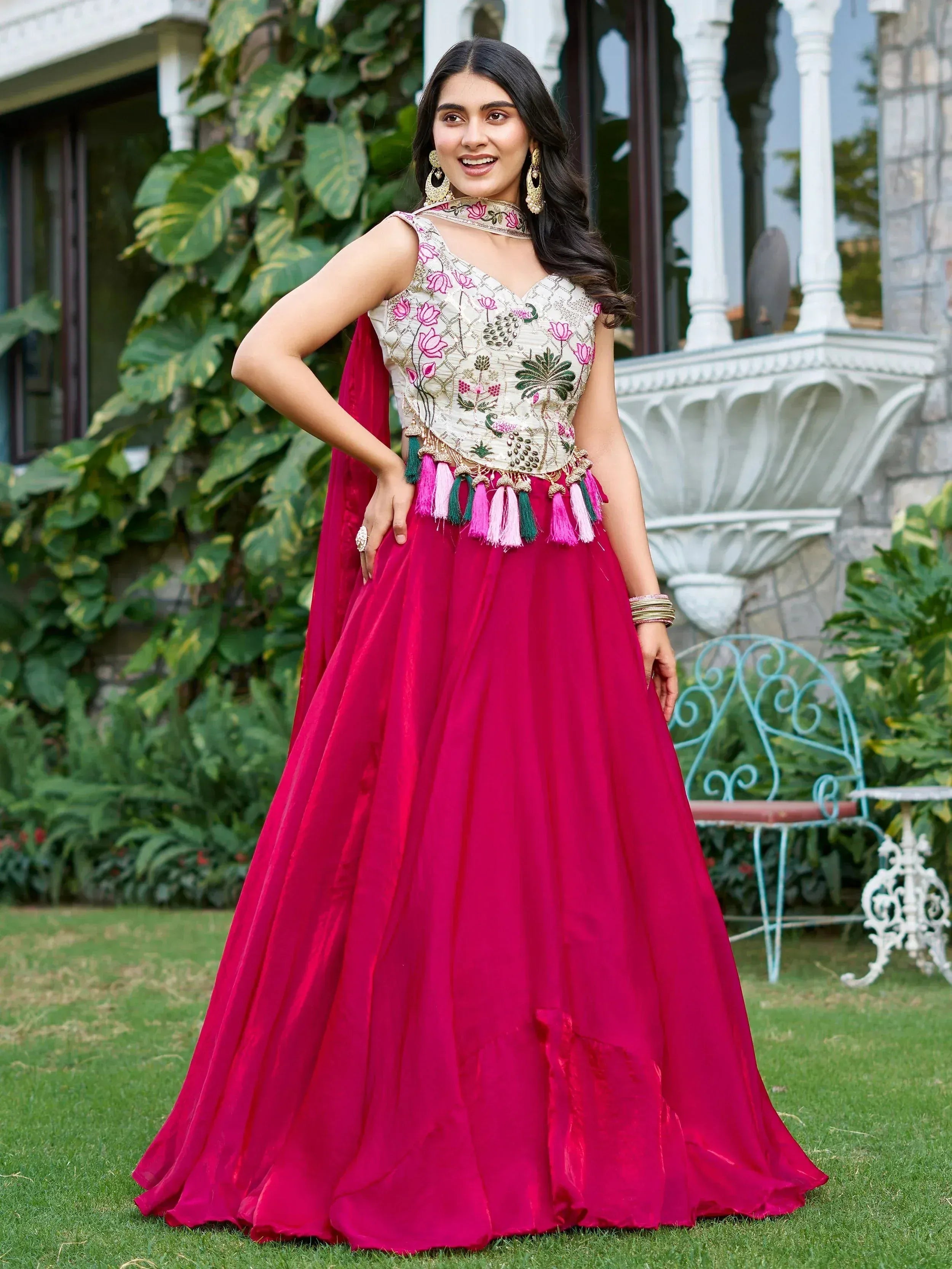 Elegant pink lehenga choli with floral embroidery and tassels, perfect for Indian ethnic wear