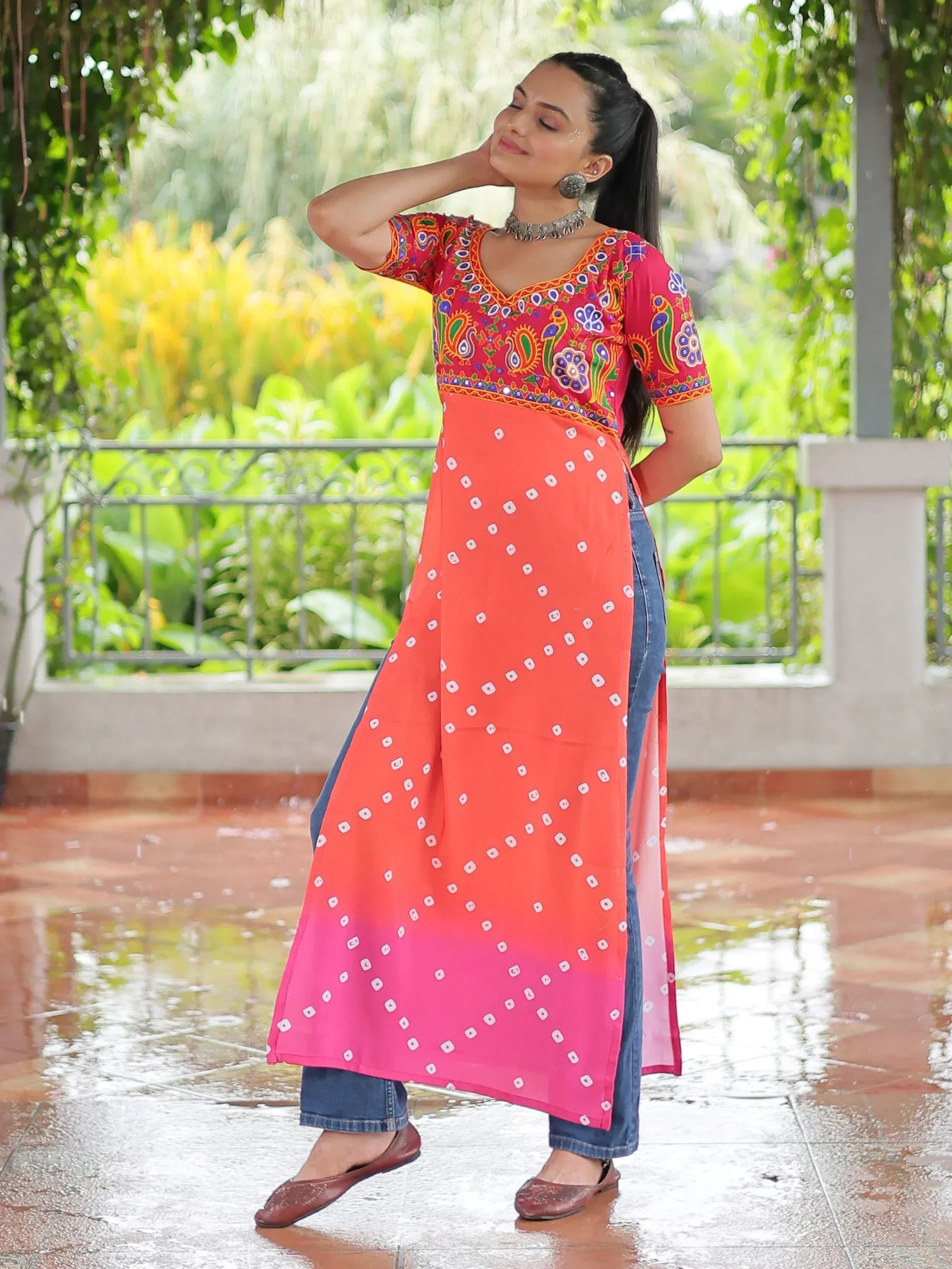 Woman in colorful embroidered kurta with ombre dupatta, styled with jeans for ethnic fusion look